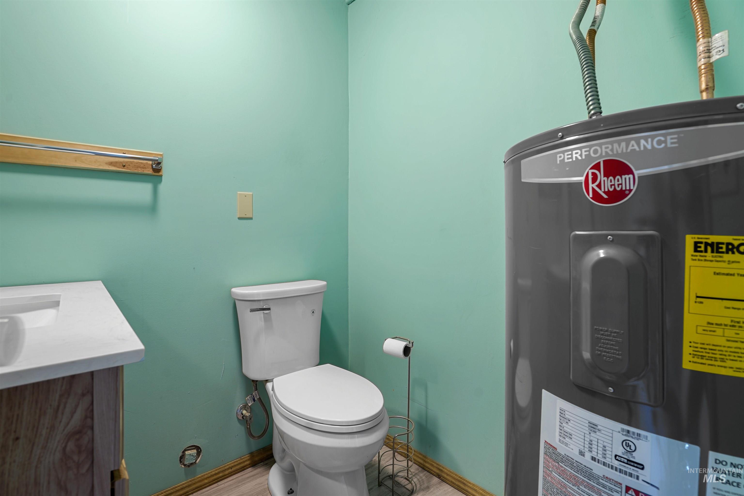 Half bathroom with water heater and vanity