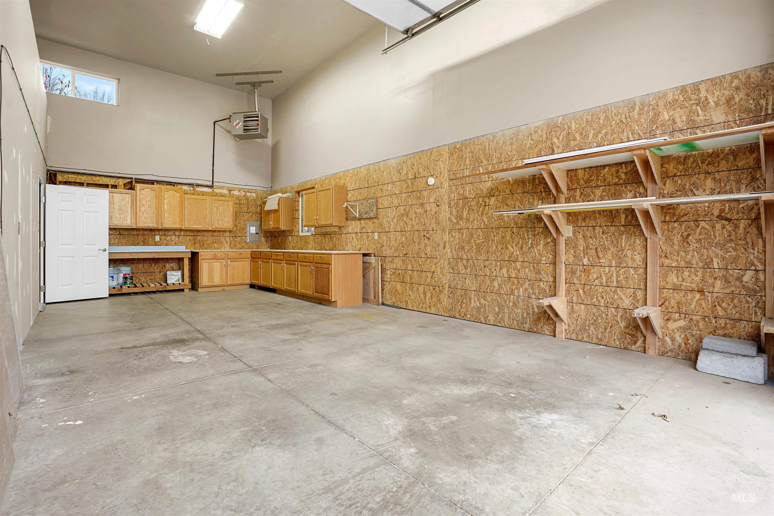 Garage featuring a heating unit