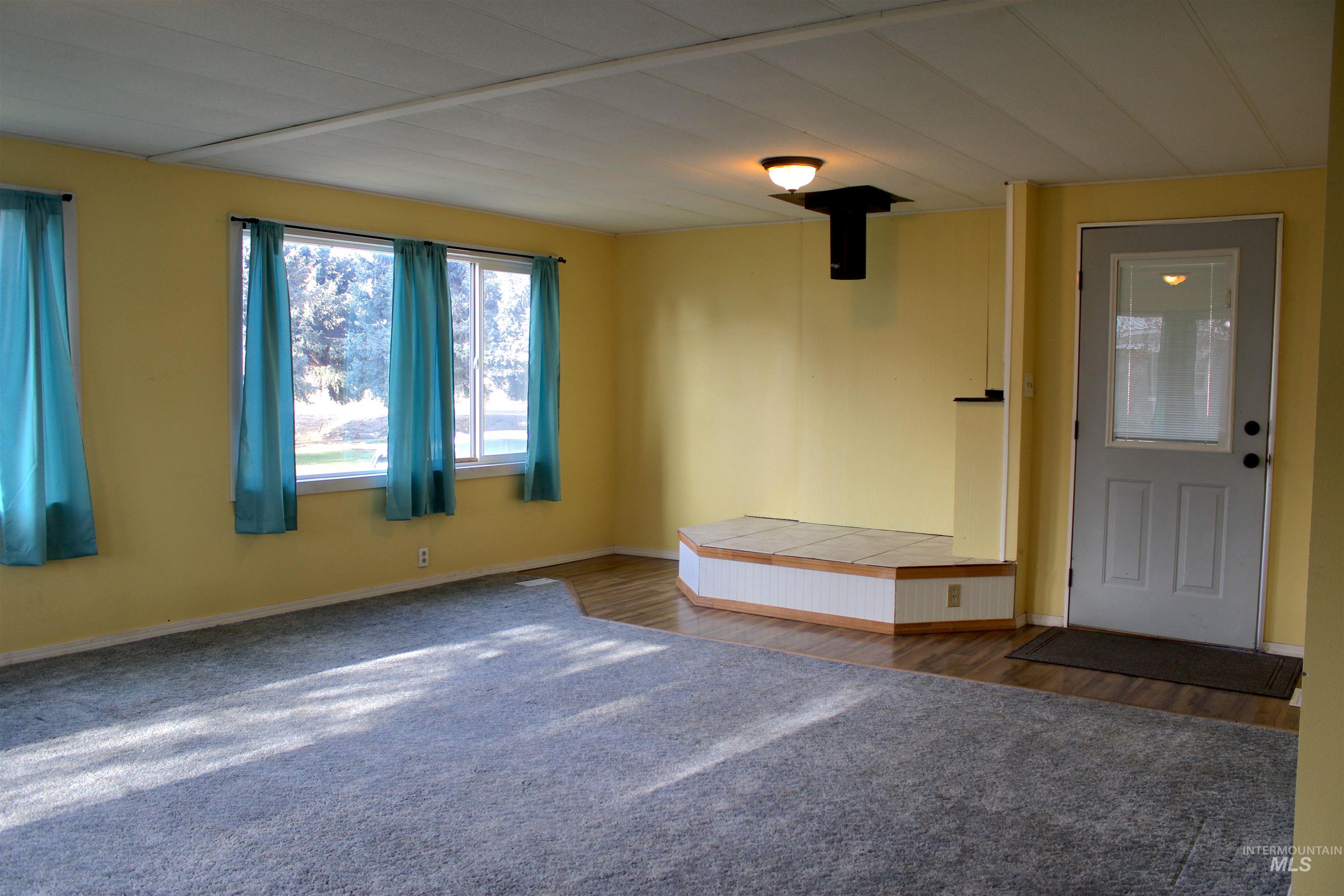 Foyer entrance with baseboards and carpet flooring