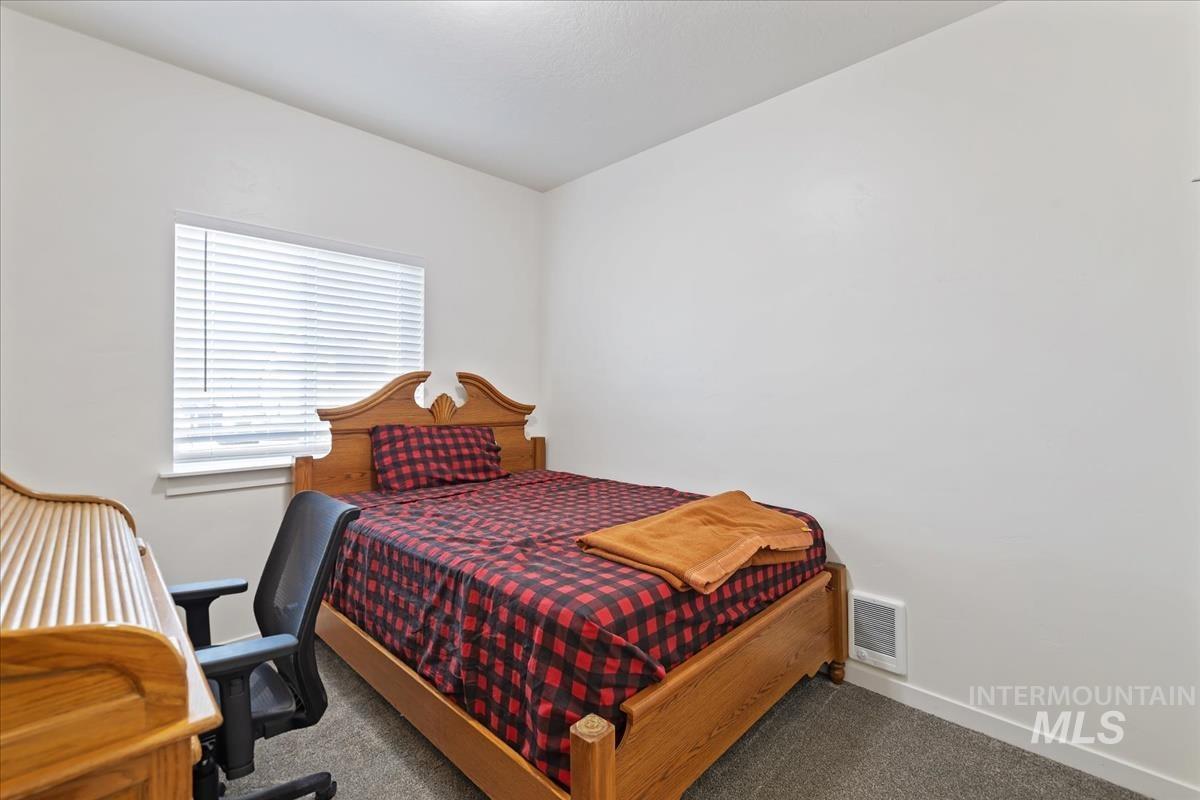 Bedroom featuring carpet floors and baseboards