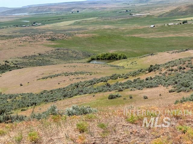 View of mountain backdrop with rural landscape