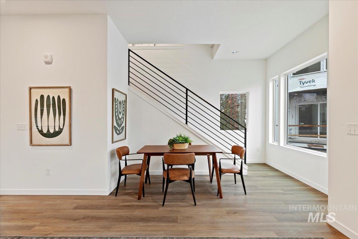 Dining area featuring light wood finished floors and stairway