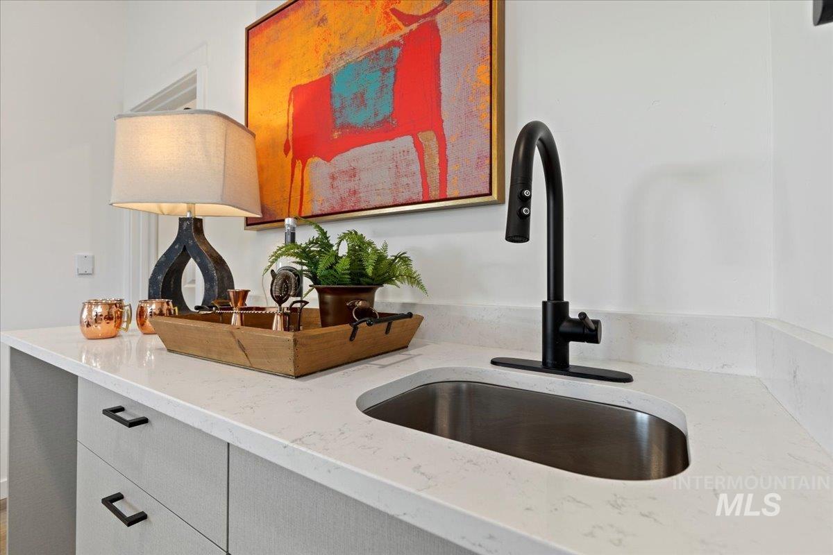 Detailed view of light stone countertops and a sink