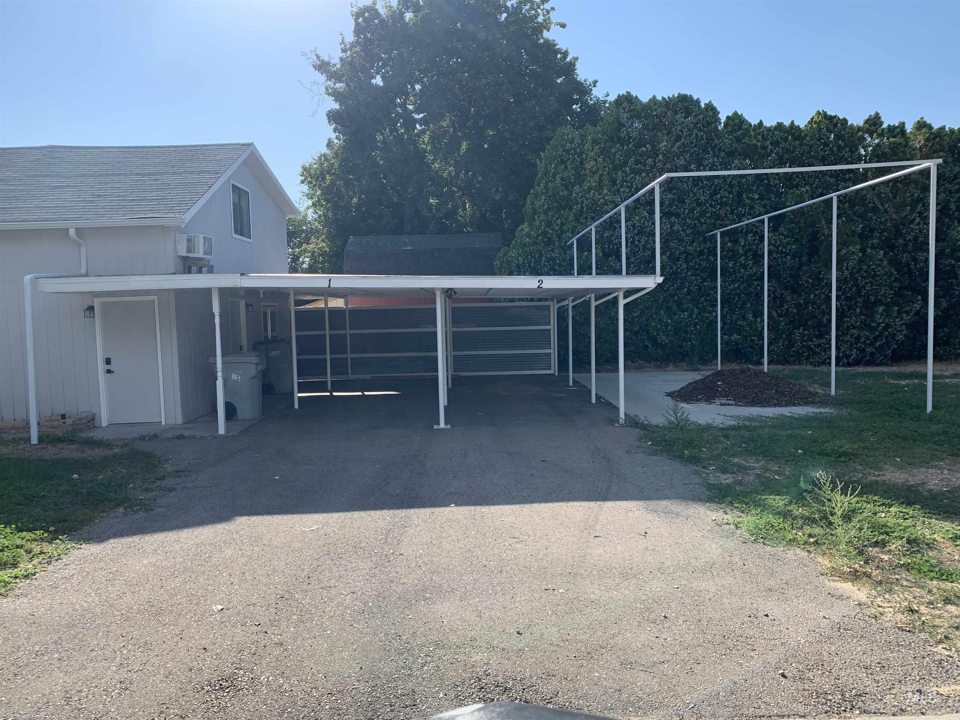 View of car parking featuring an attached carport and framed RV parking area.