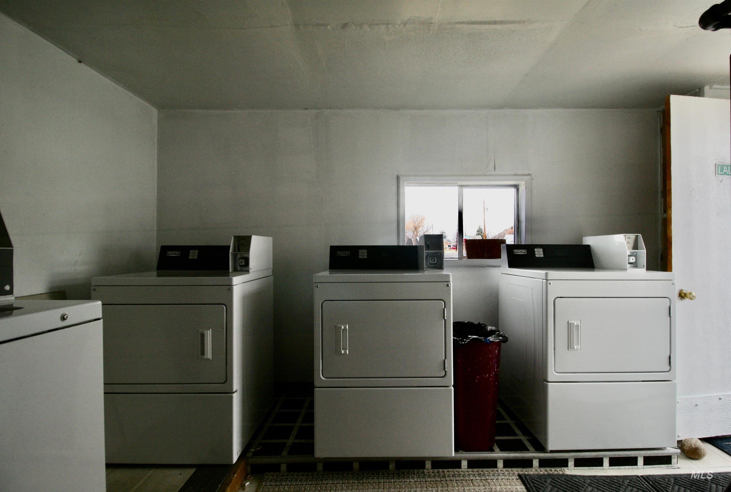 Communal laundry room with independent washer and dryer