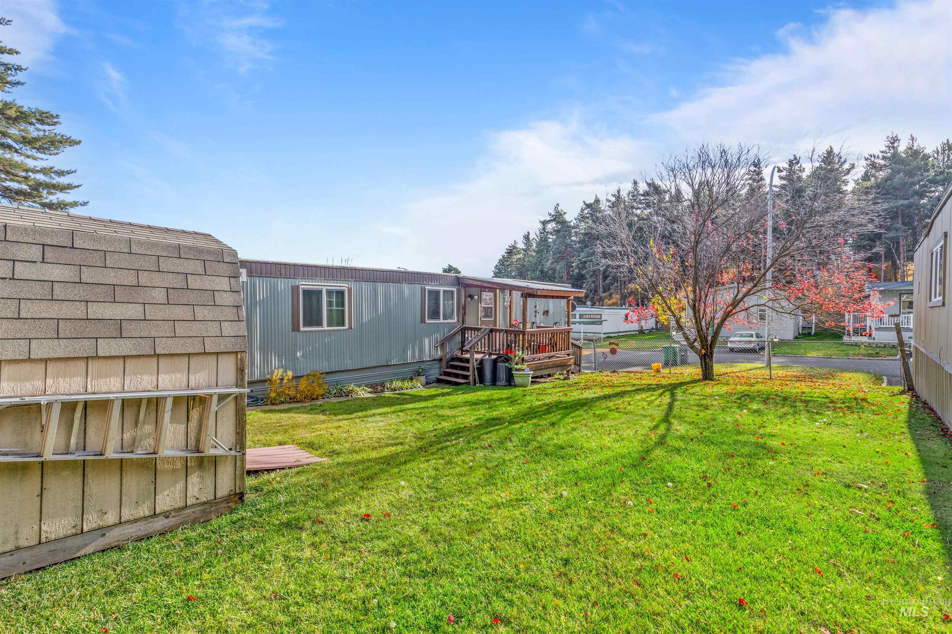 Back of property featuring a lawn