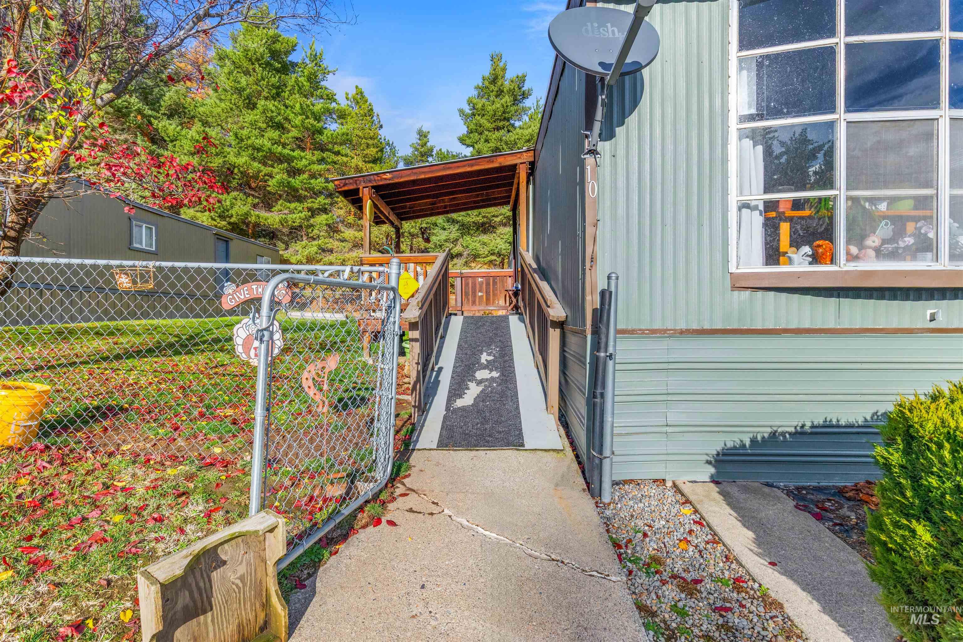 View of side of home with a gate