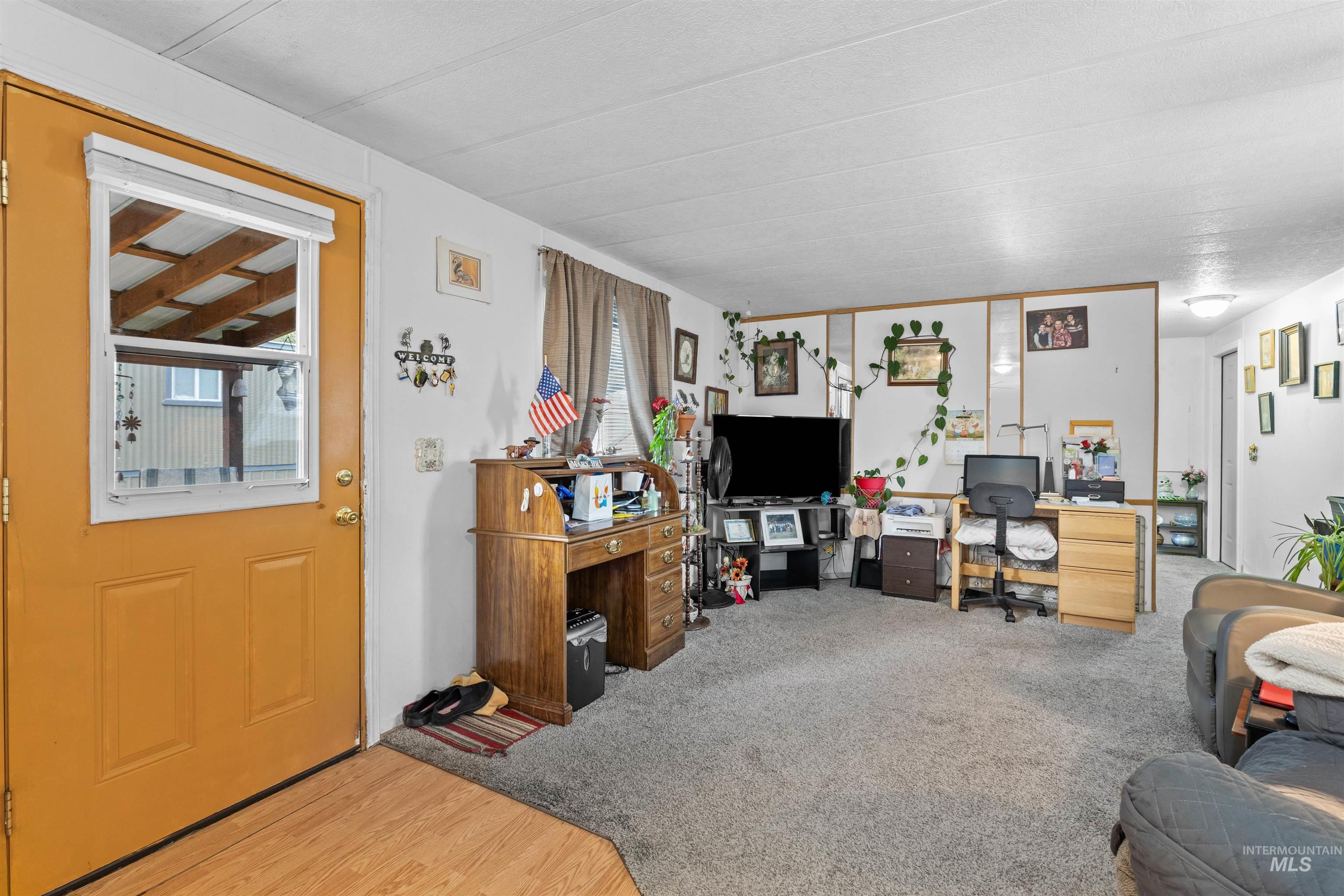 Living room with light carpet and light wood finished floors