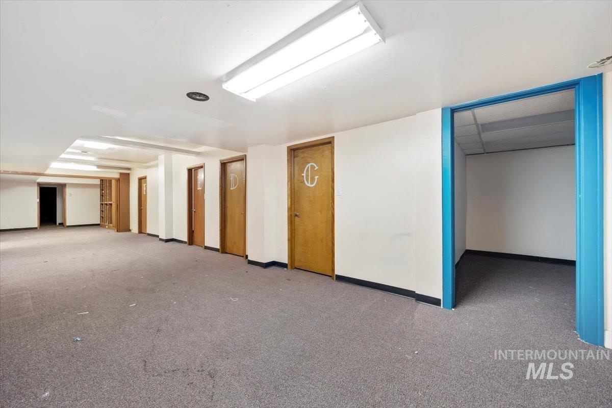 Spare room featuring carpet and baseboards
