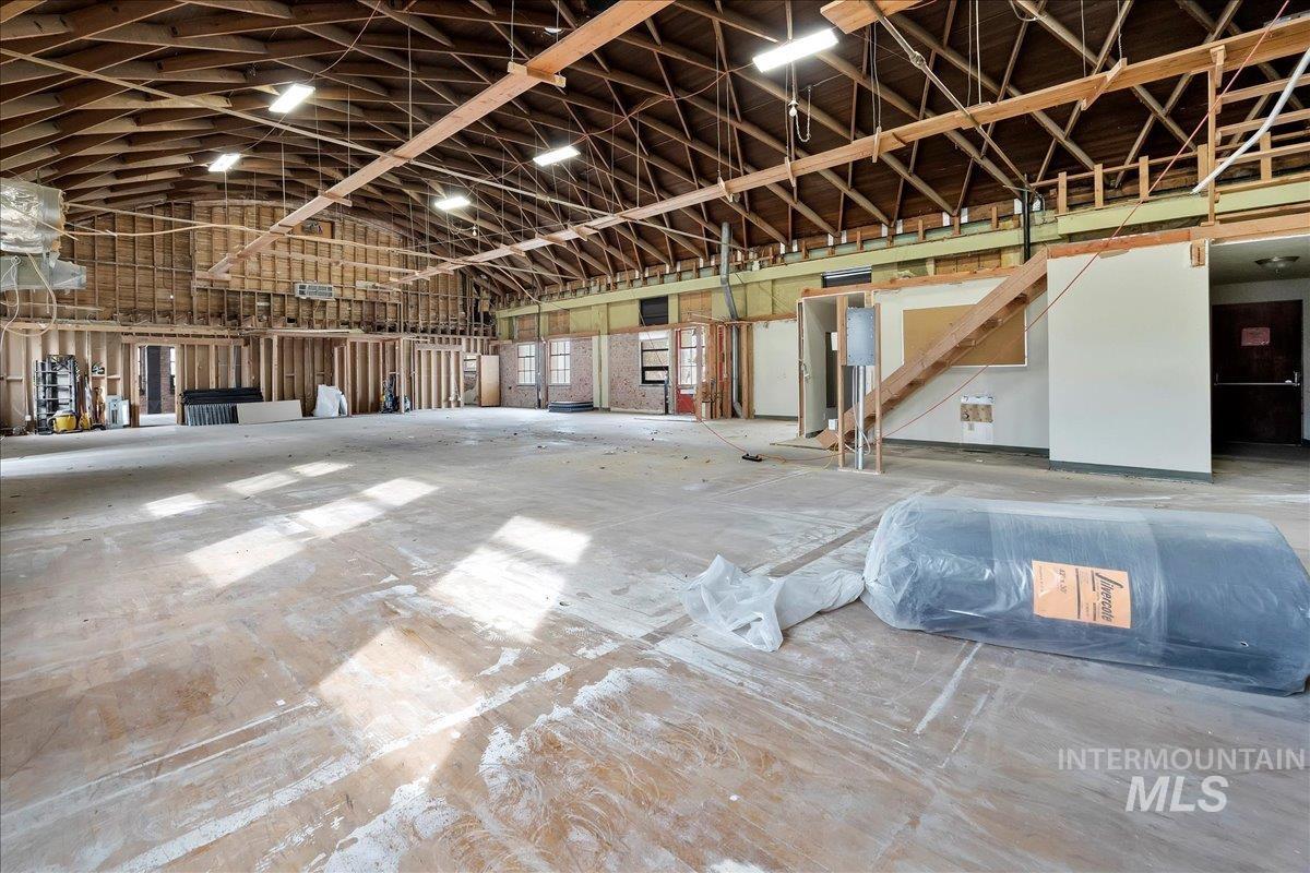 Misc room featuring a garage and high vaulted ceiling