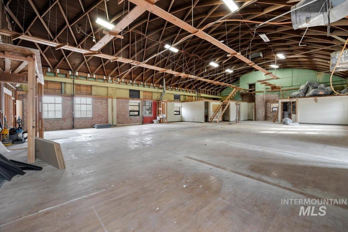 Miscellaneous room with a garage and lofted ceiling