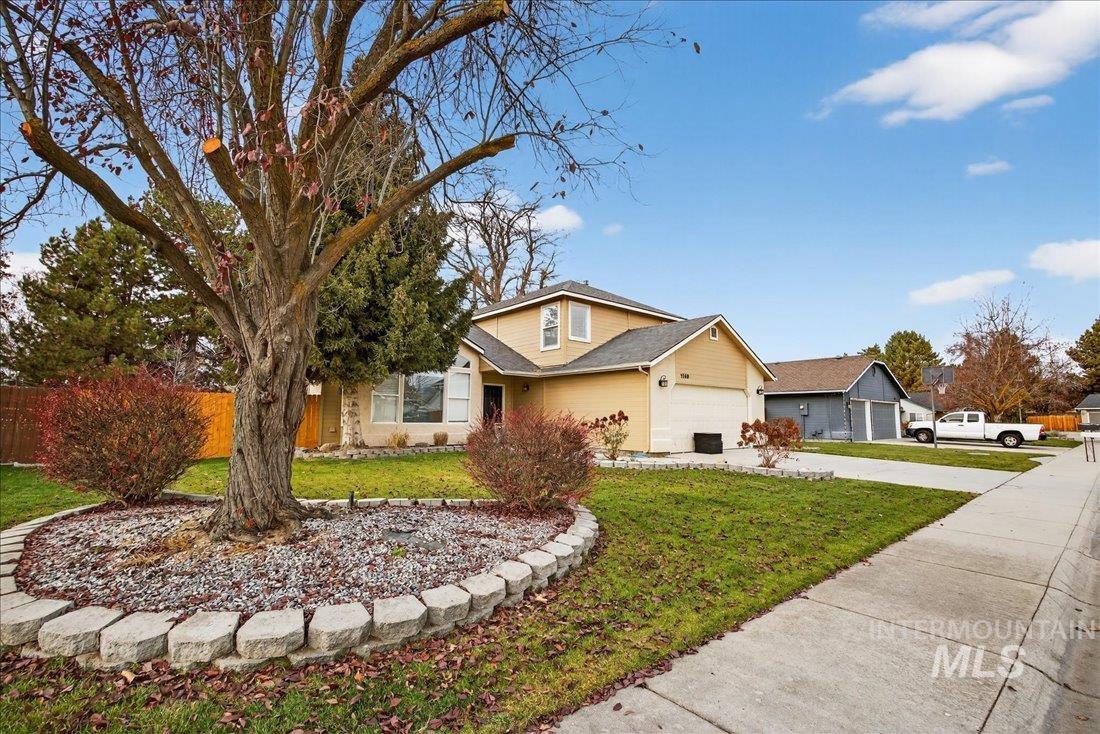 Traditional-style house featuring driveway and a garage