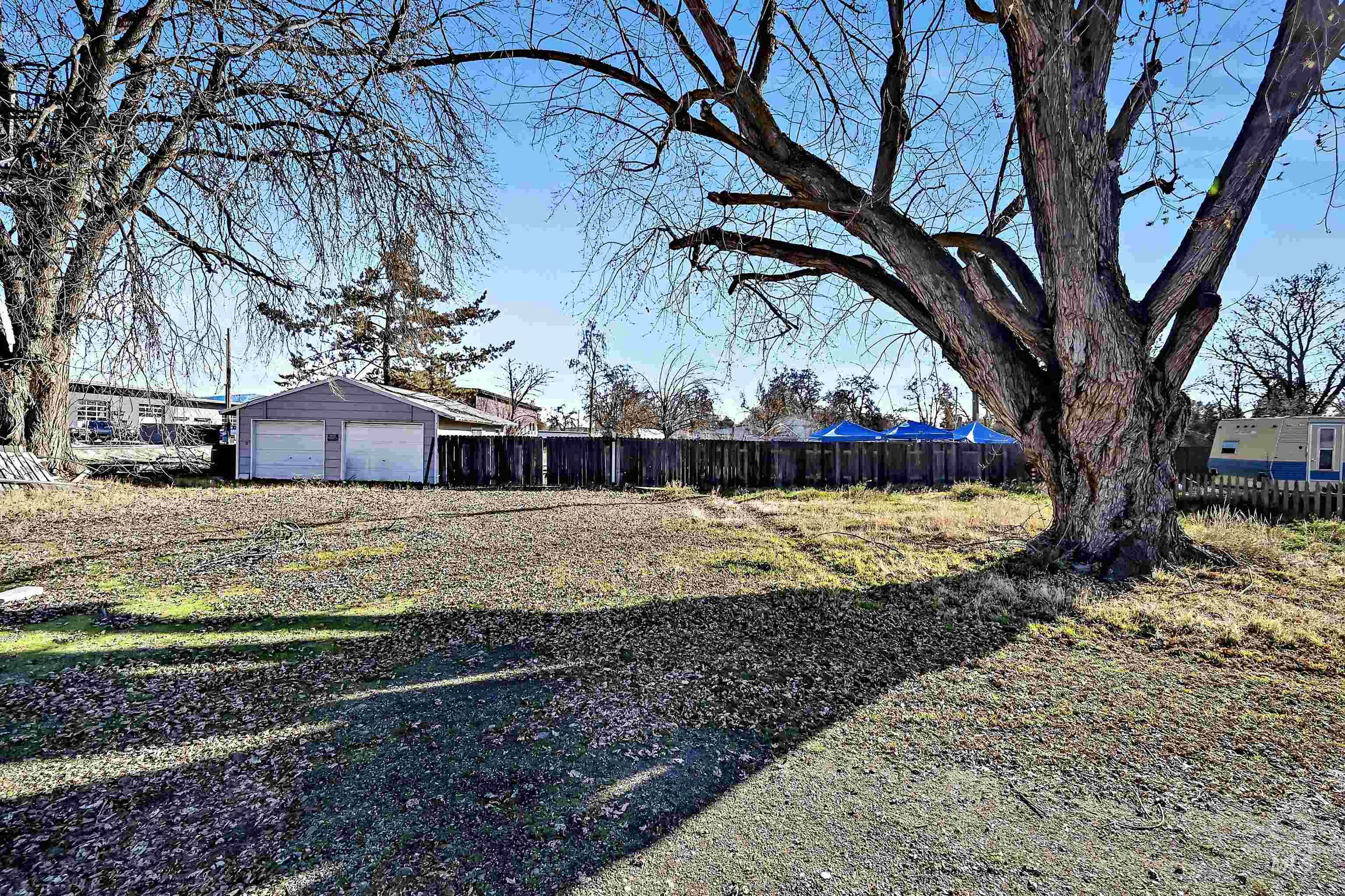 View of yard featuring a detached garage and an outbuilding