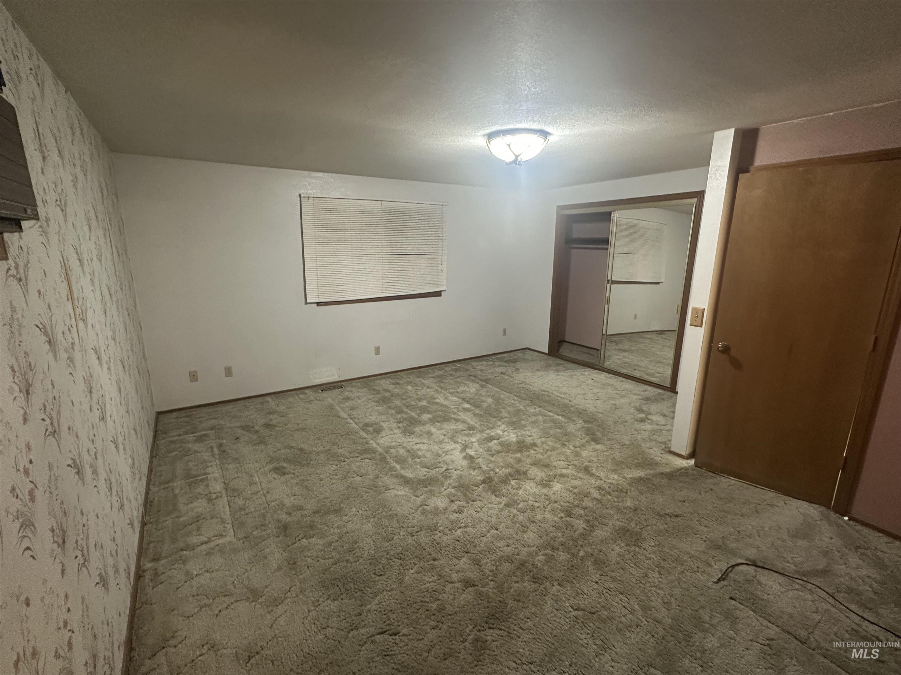 Unfurnished bedroom with a closet and carpet