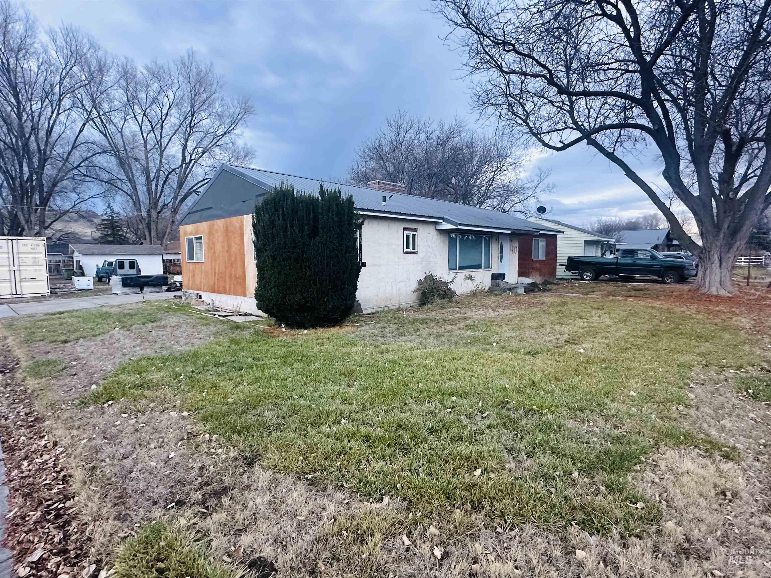 Back of house featuring a lawn