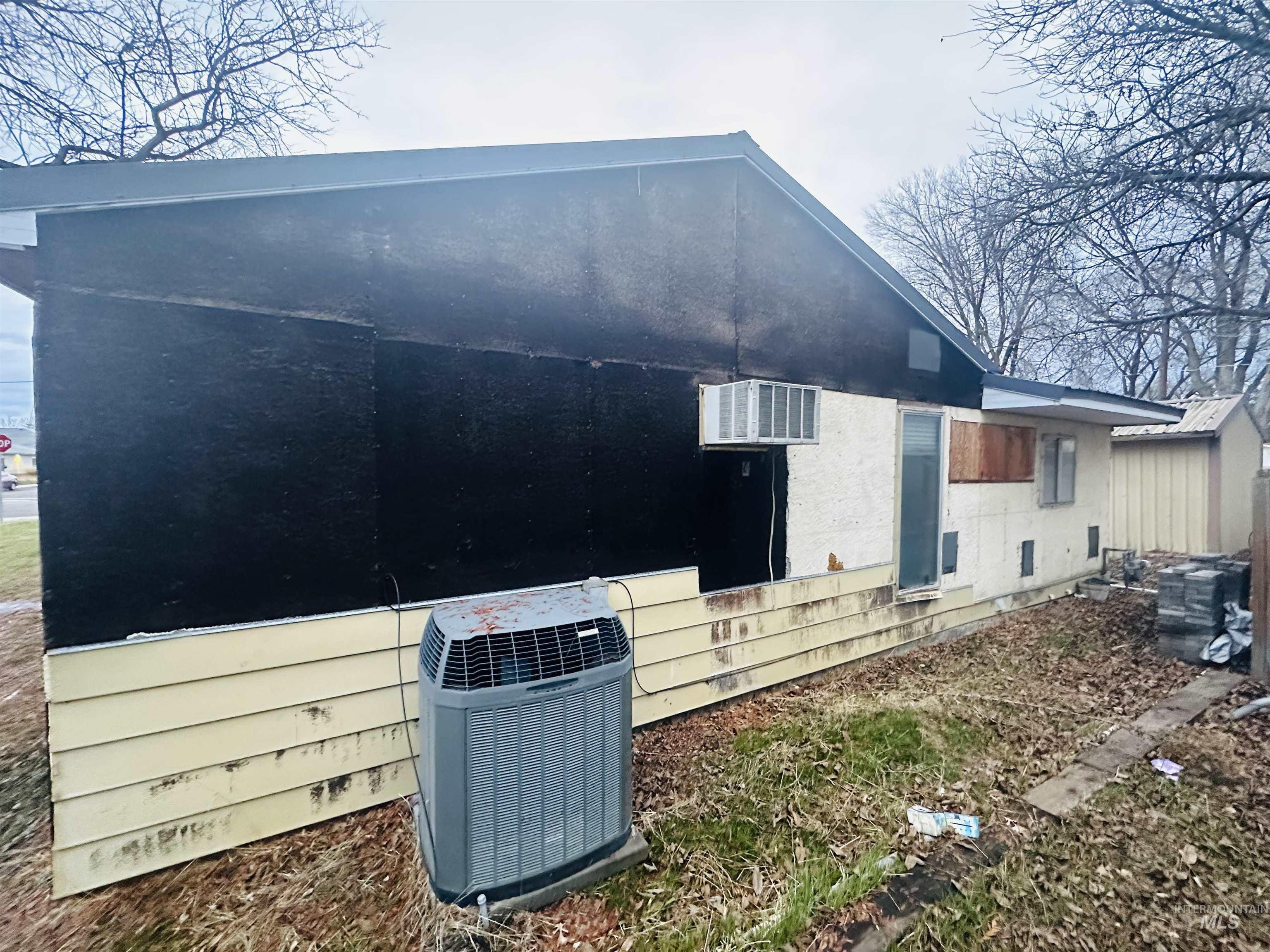 View of side of home with a cooling unit