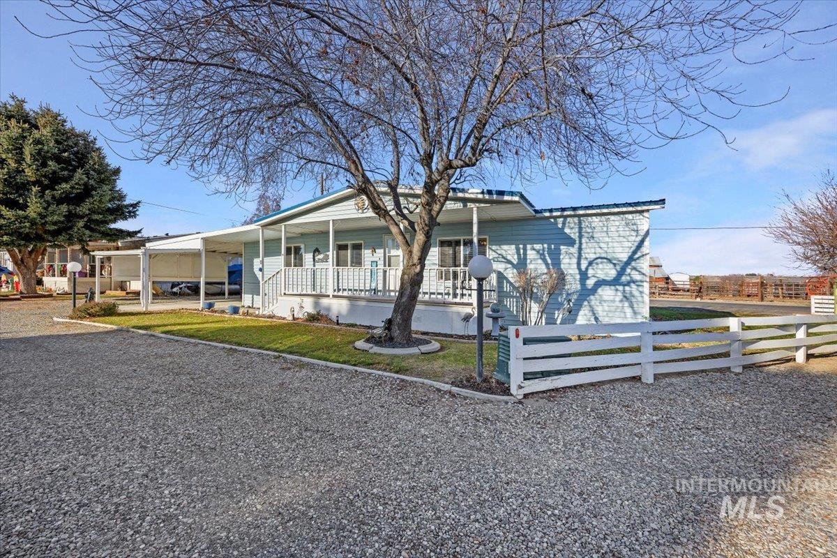 View of front of house with a porch and a fenced front yard