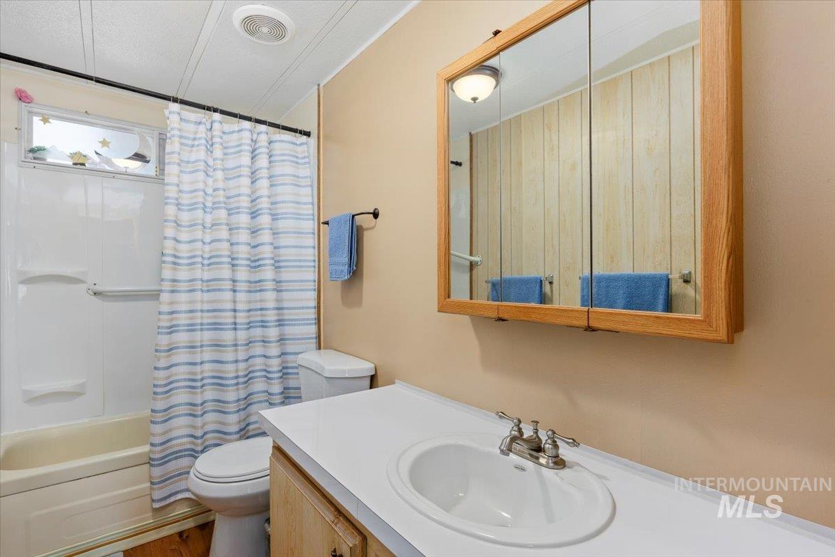 Full bathroom featuring shower / bath combo and vanity
