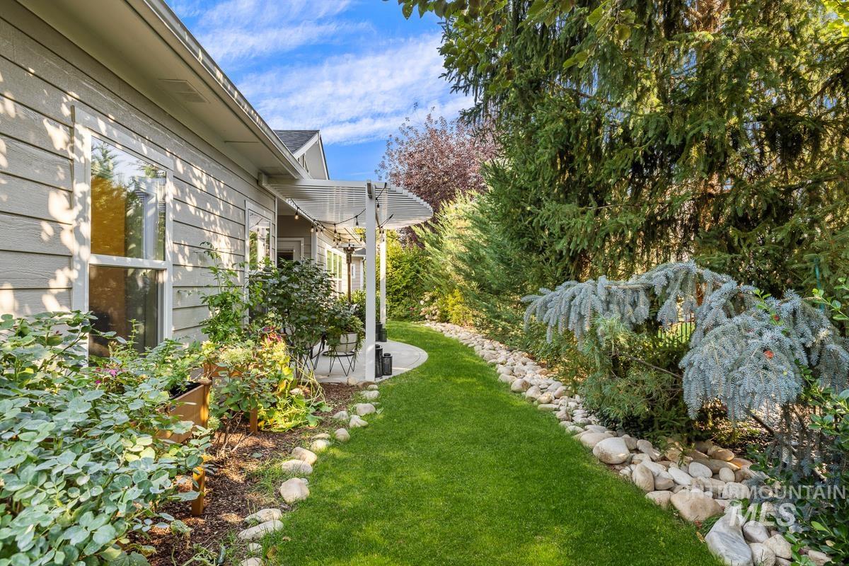 View of green lawn featuring a patio area