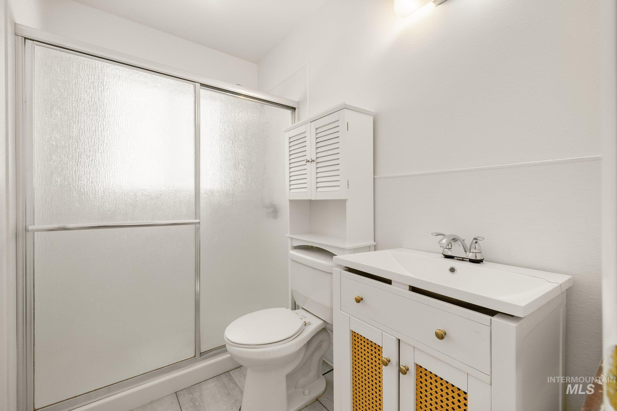 Bathroom featuring a stall shower and vanity