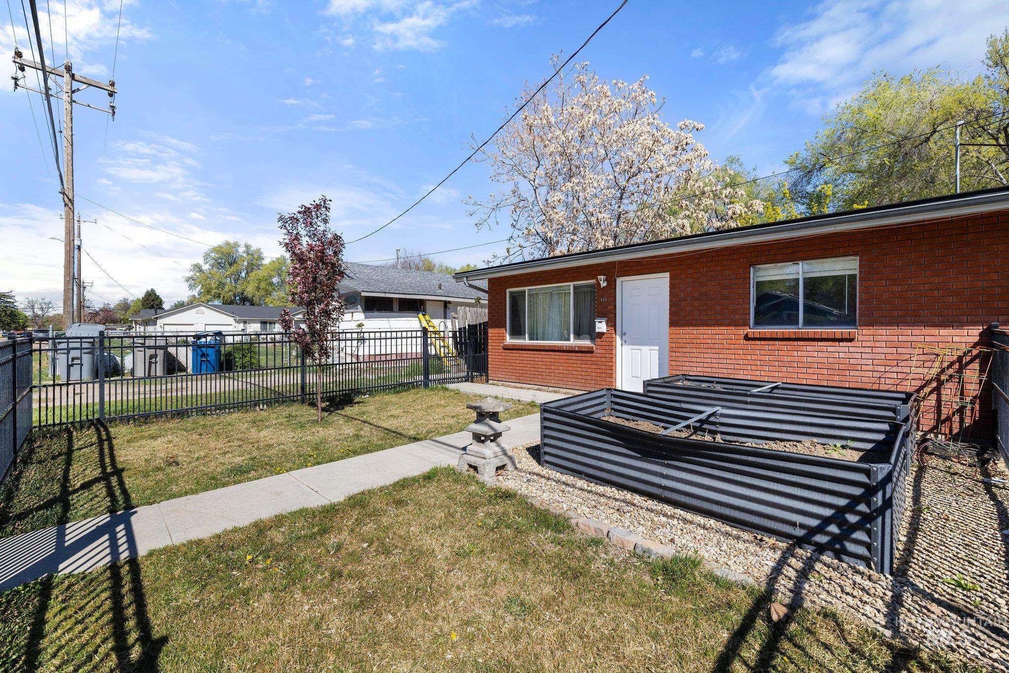 Rear view of property featuring brick siding and a patio