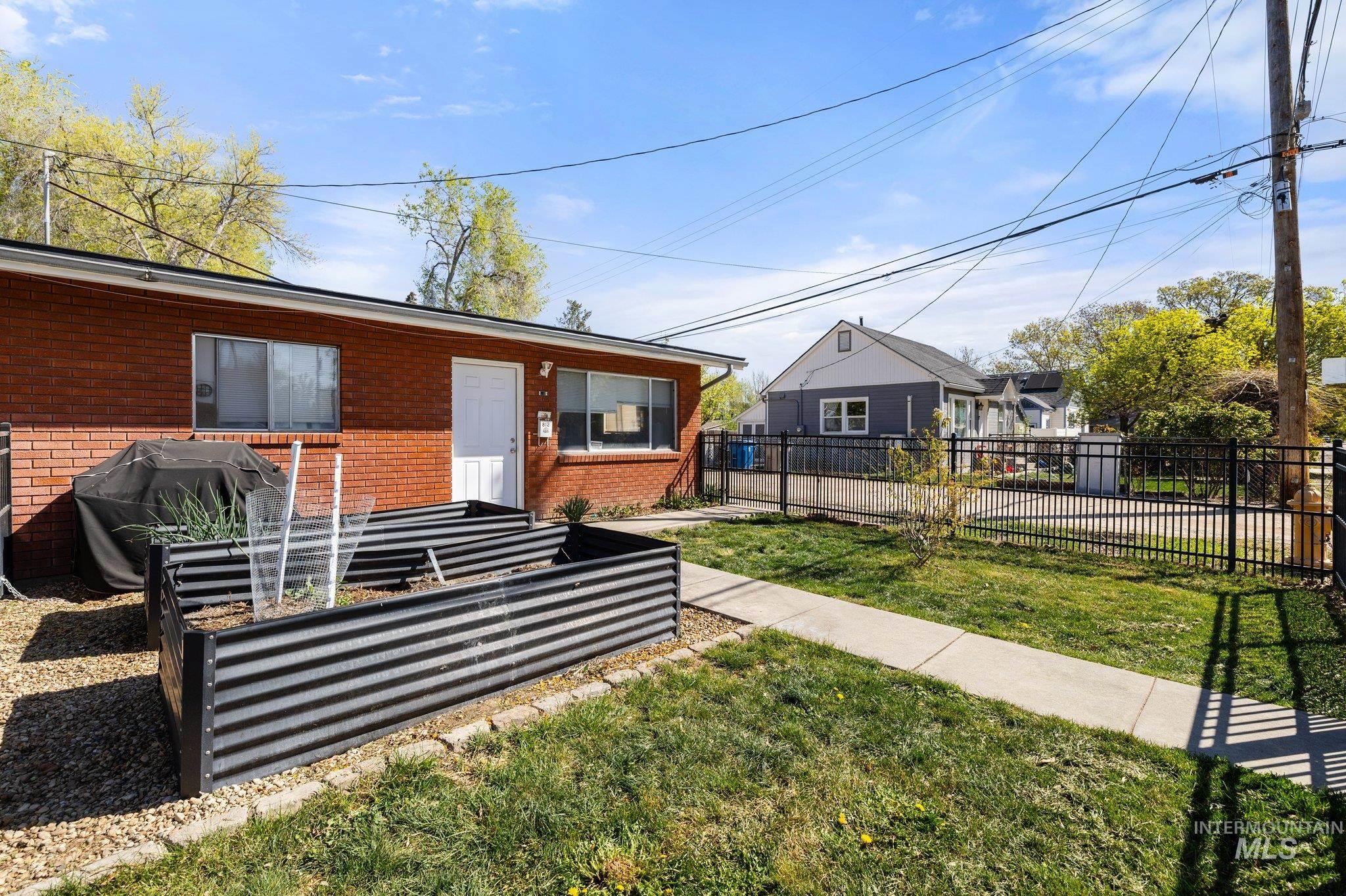 View of yard with a garden and a patio
