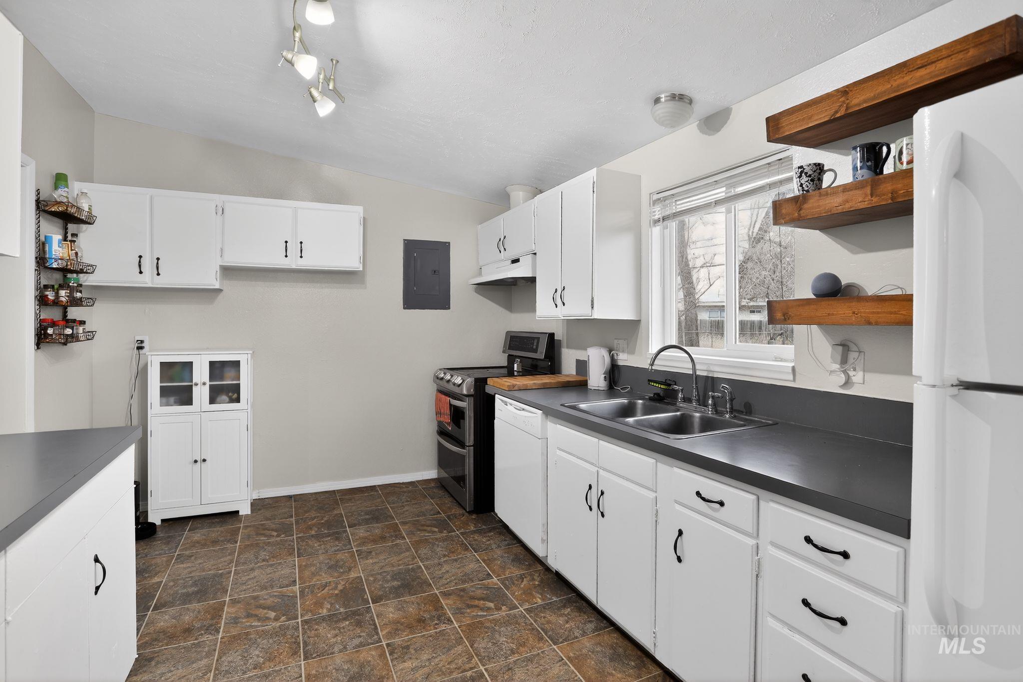 Kitchen featuring open shelves, white cabinetry, white appliances, and lofted ceiling