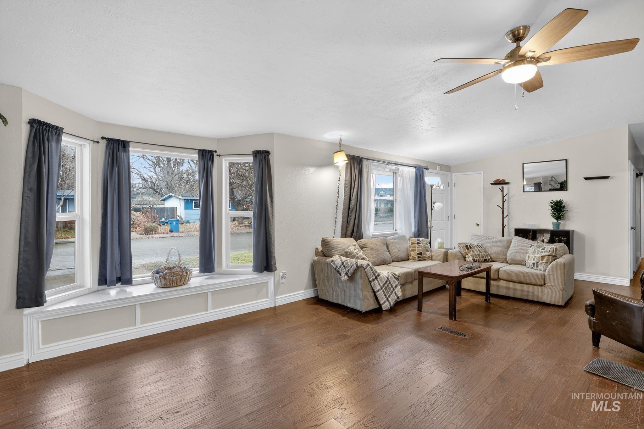 Living area featuring wood finished floors and ceiling fan
