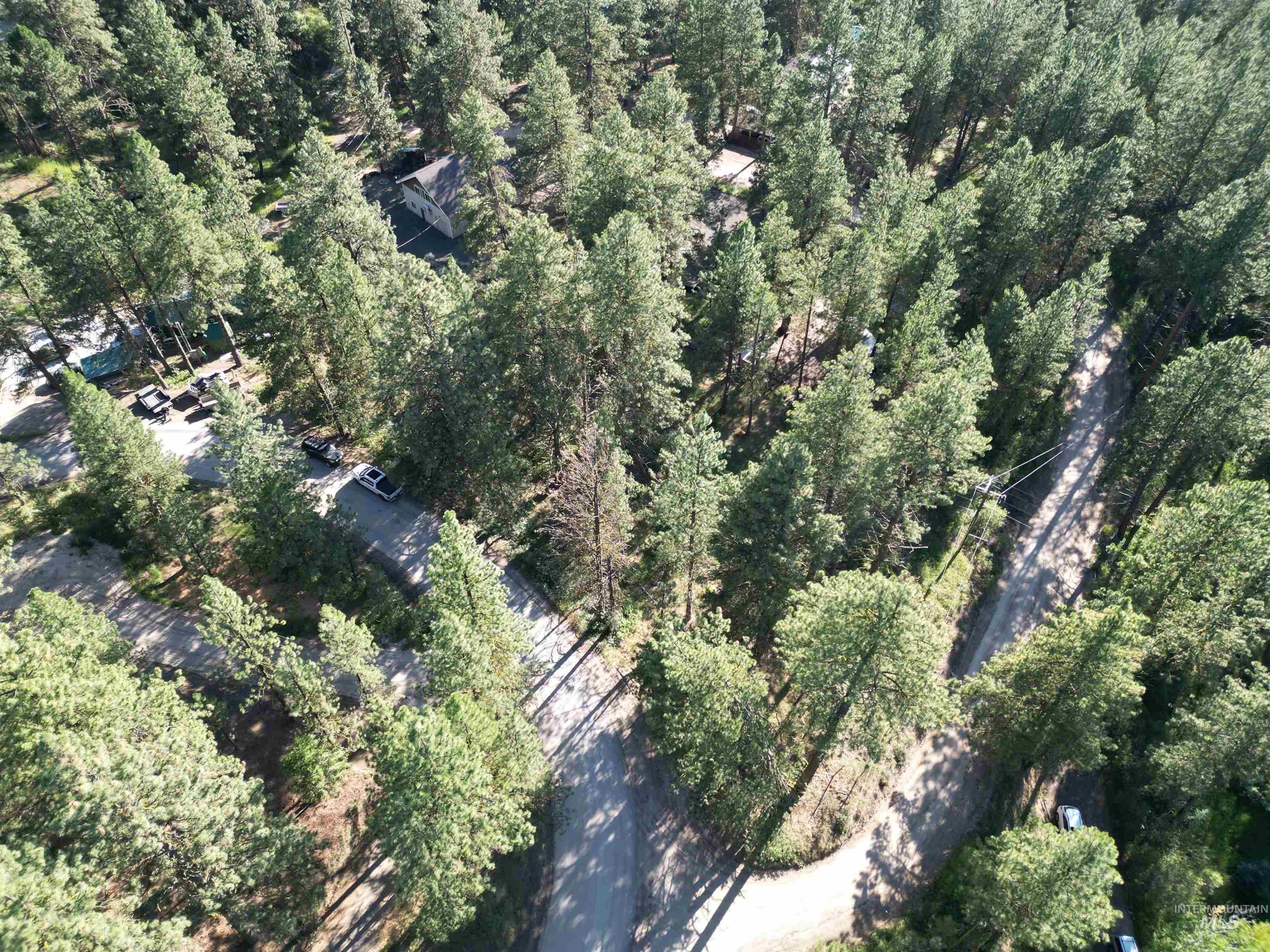 Aerial view of property's location with a forest