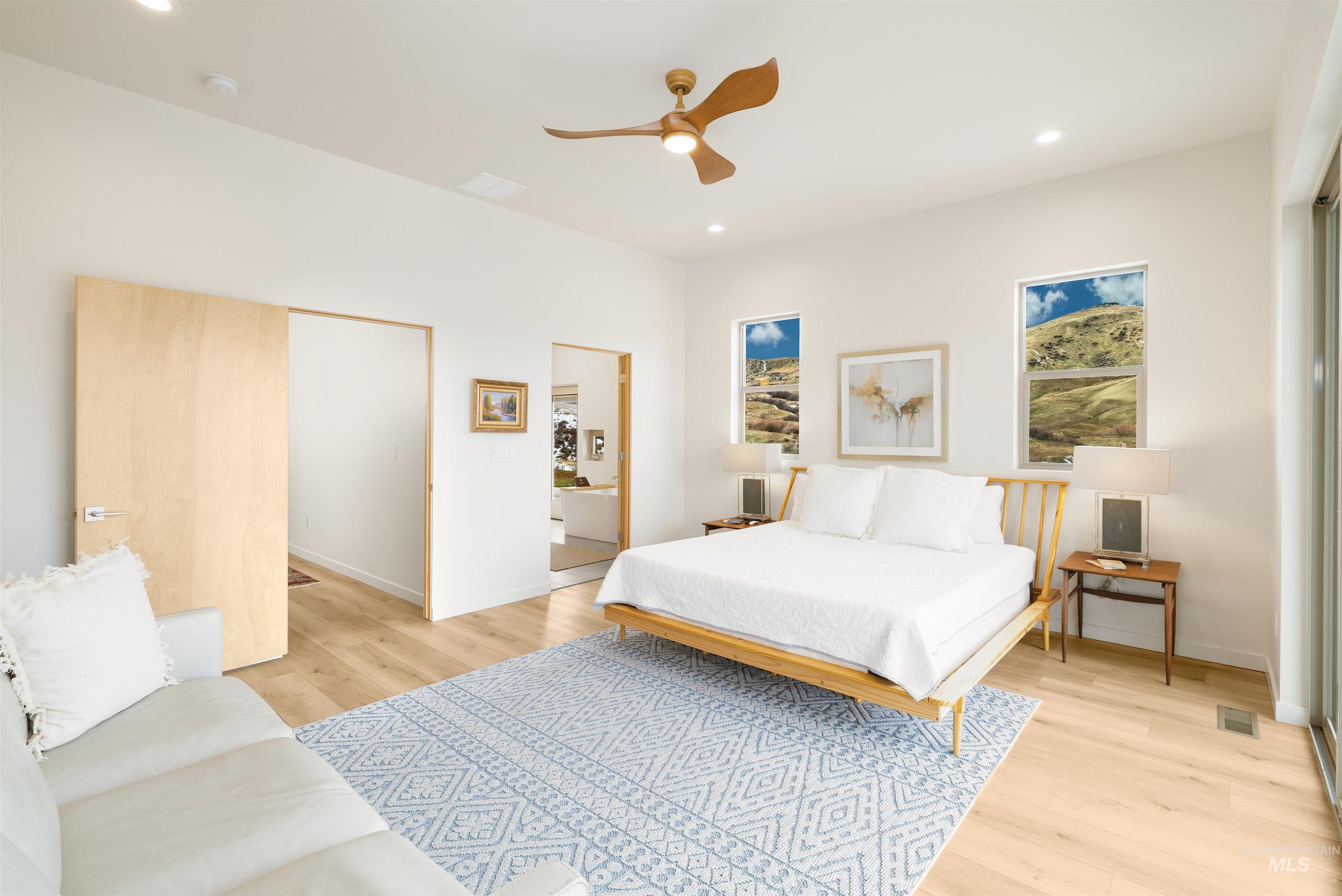Bedroom with light wood finished floors, a closet, recessed lighting, and ceiling fan