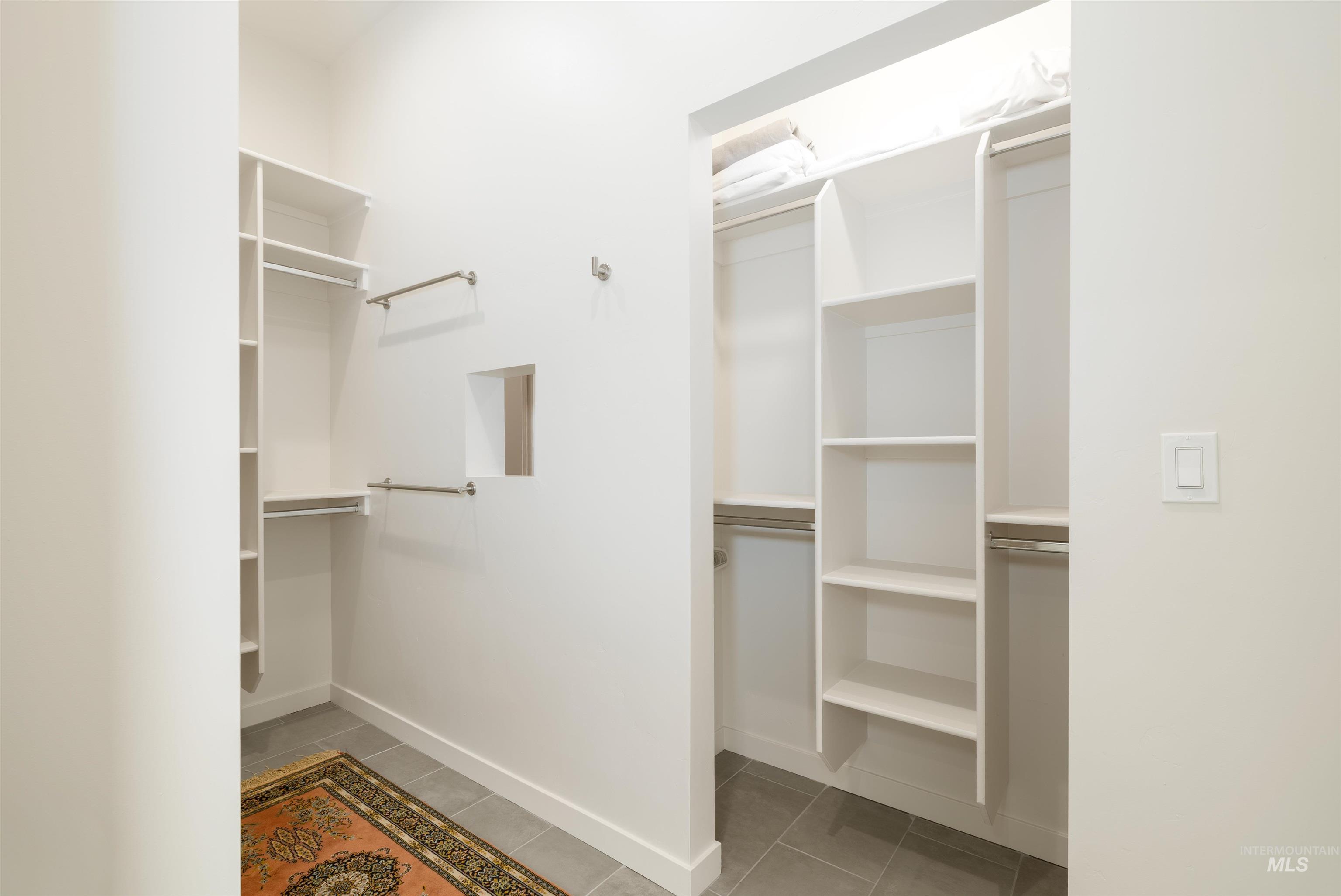 Spacious closet with light tile patterned floors