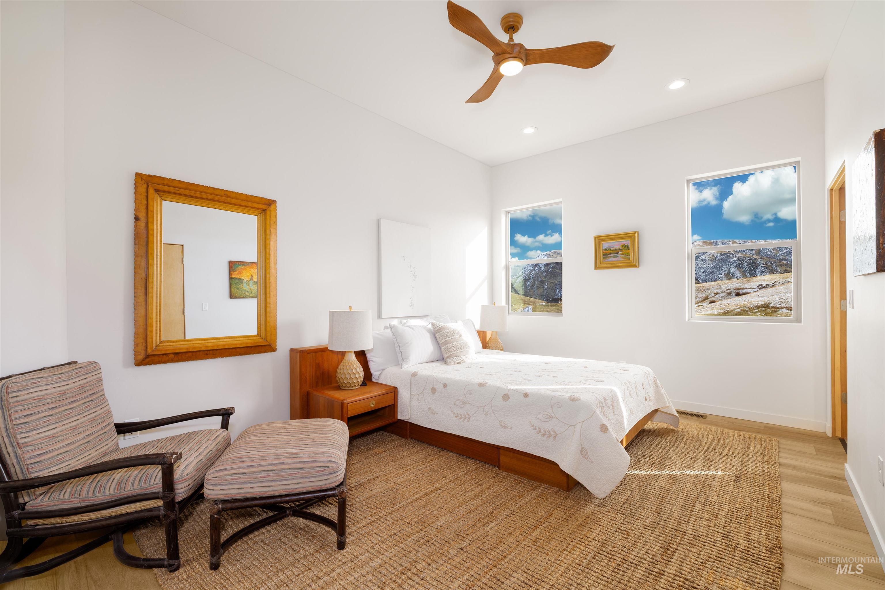Bedroom with wood finished floors, a ceiling fan, and recessed lighting