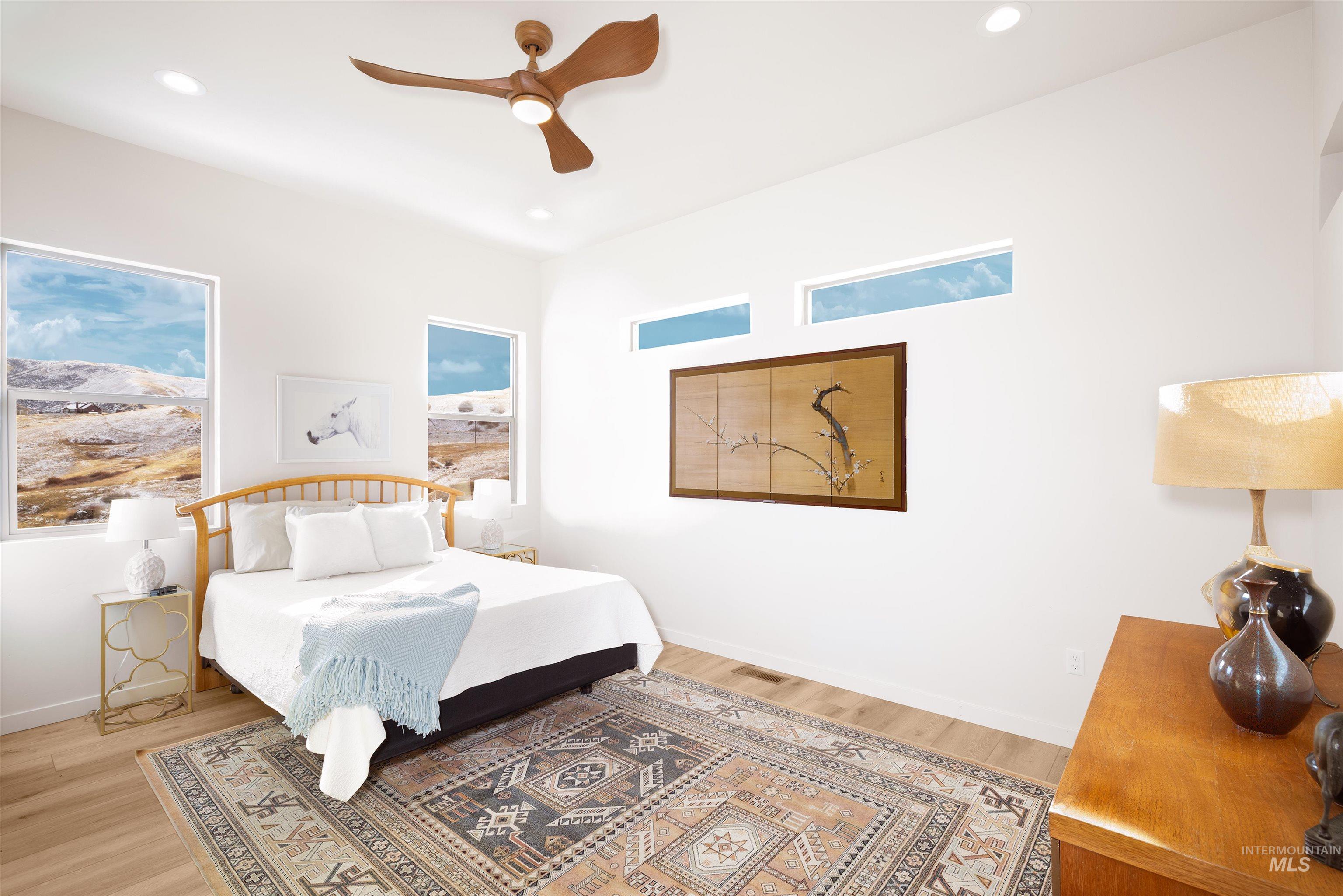 Bedroom with a ceiling fan, light wood-type flooring, and recessed lighting