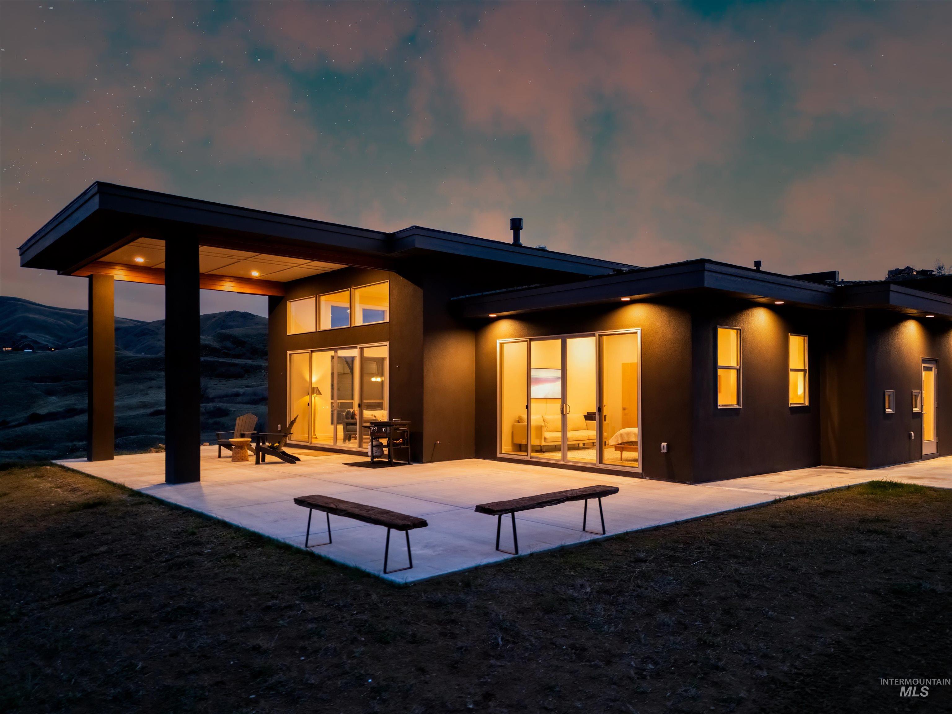 Back of property with stucco siding and a patio area