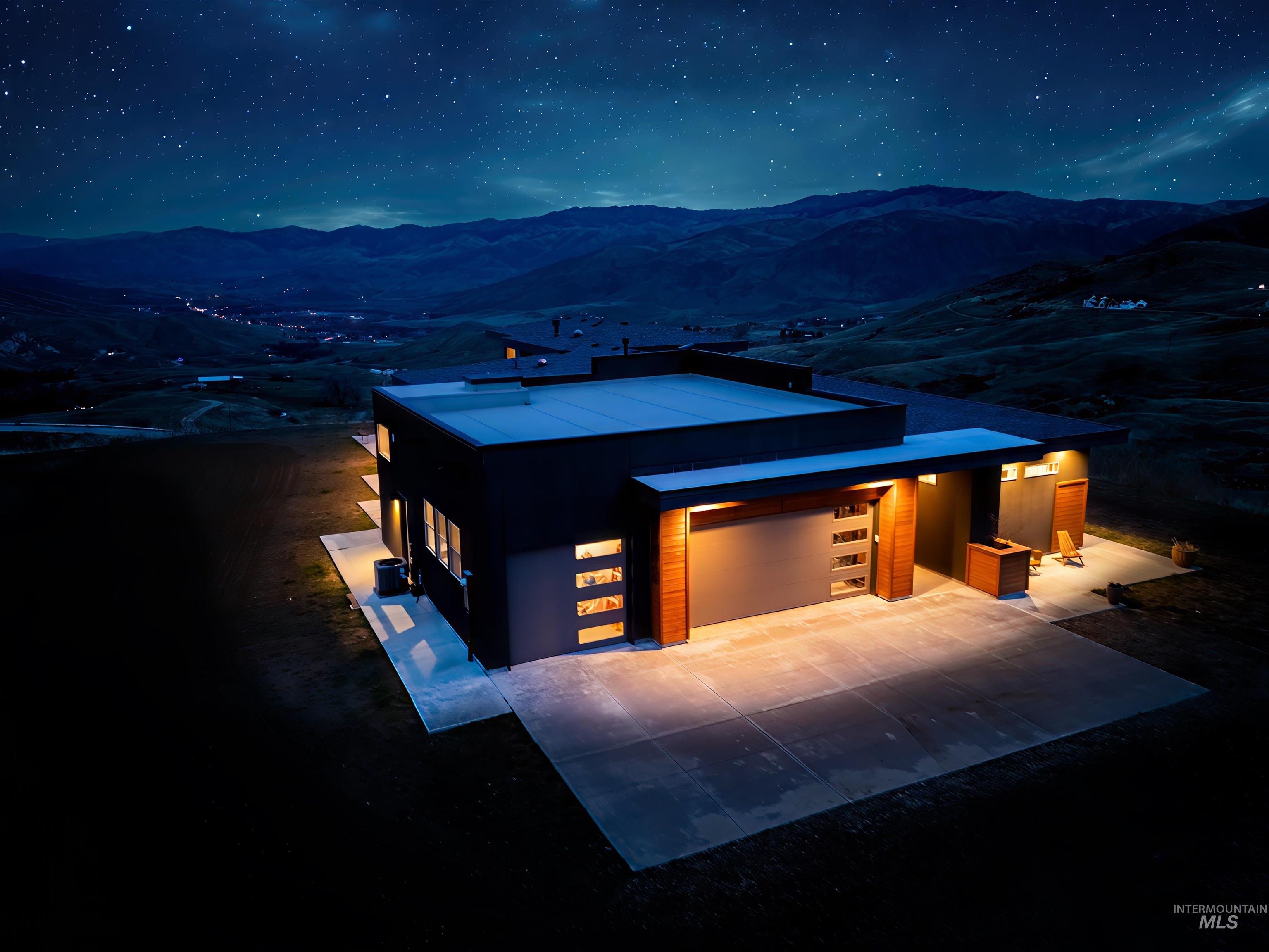 Contemporary house with driveway and a mountain view
