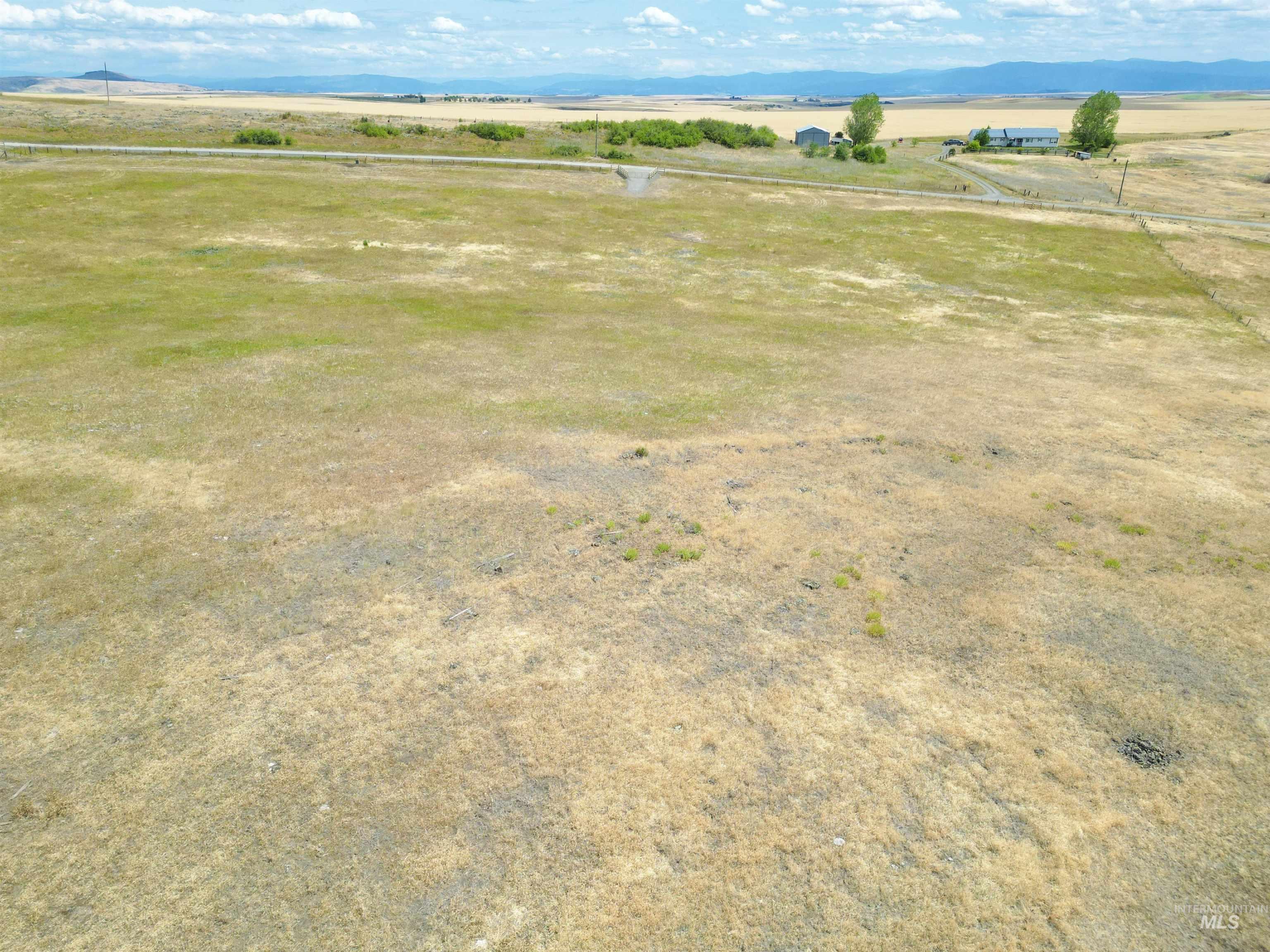 Overview of rural landscape featuring a mountainous background