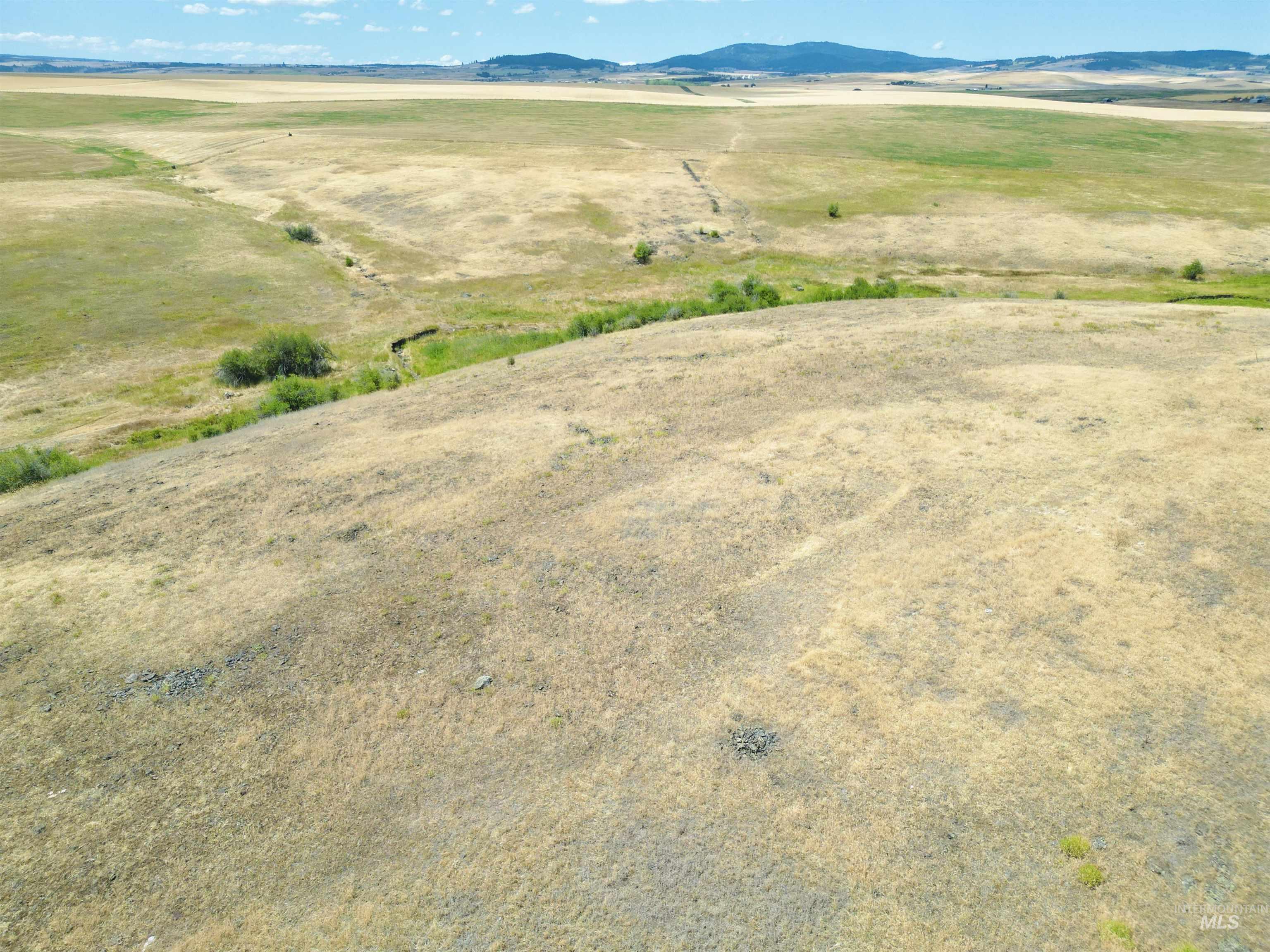 View of mountain background featuring rural landscape