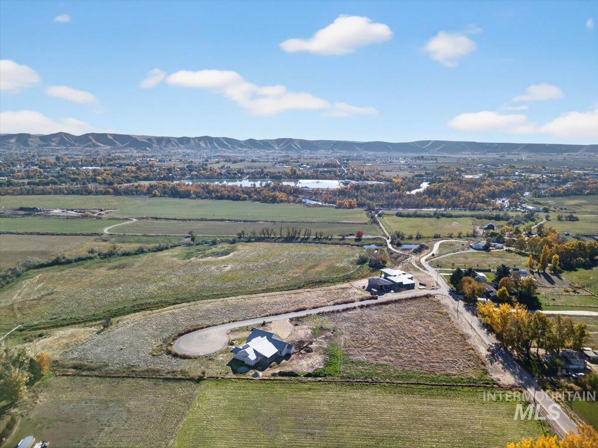 Aerial view of property's location with rural landscape and mountains