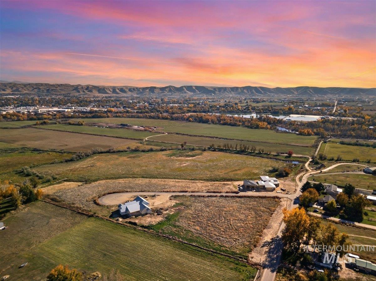 Aerial view of property and surrounding area with rural landscape and mountains