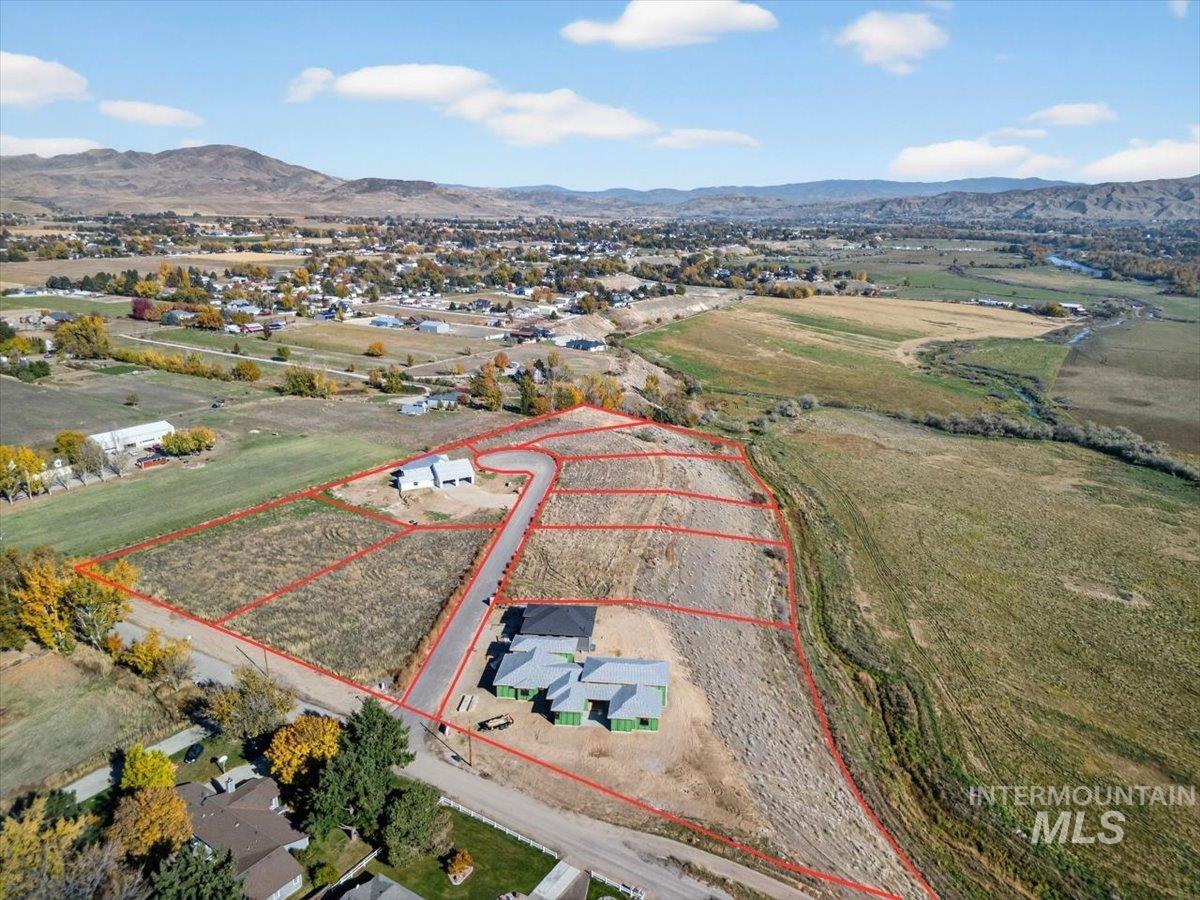 Overview of rural landscape featuring property parcel outlined and a mountain backdrop