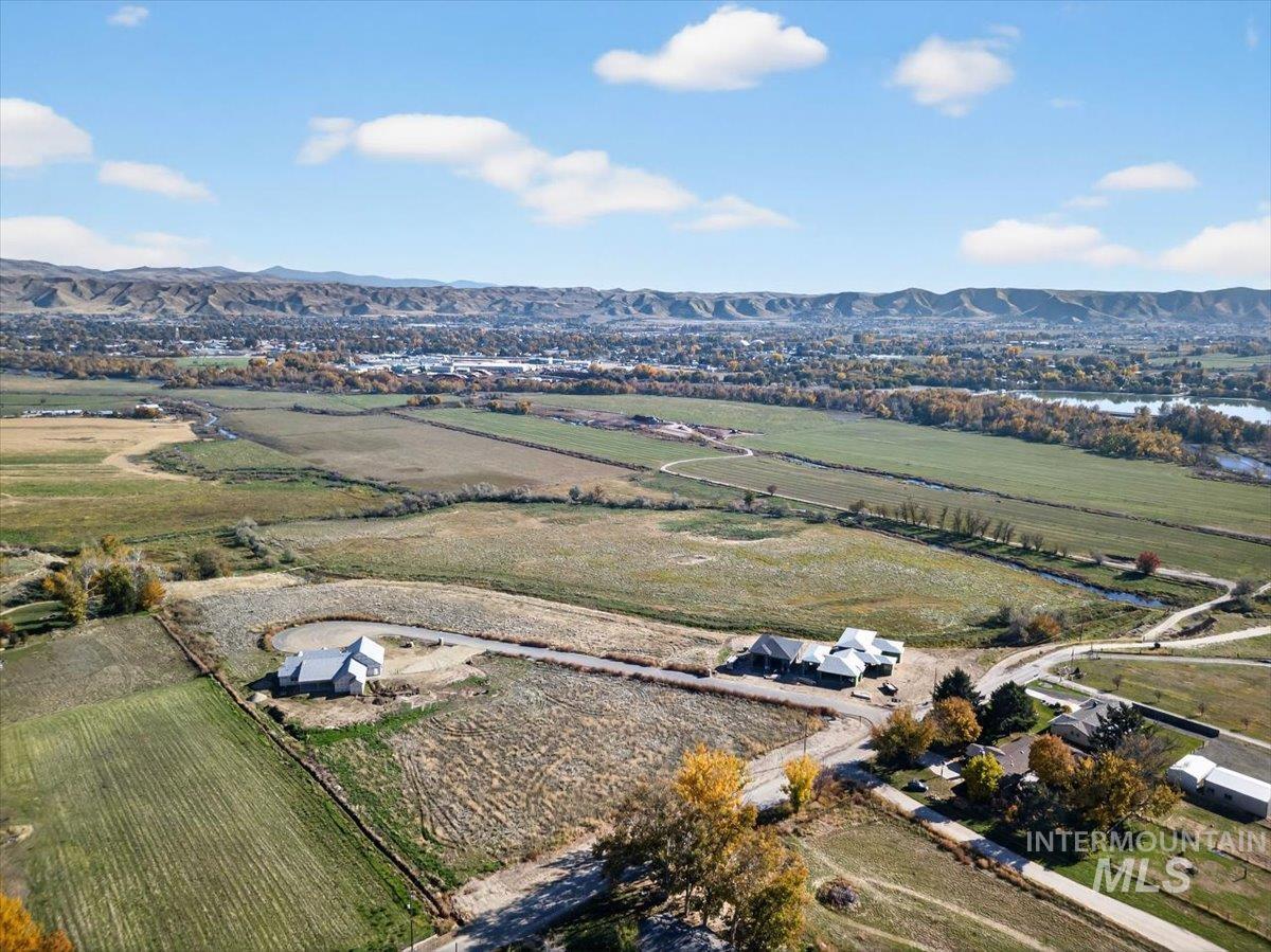 View of property location with rural landscape, a mountain backdrop, and rows of crops