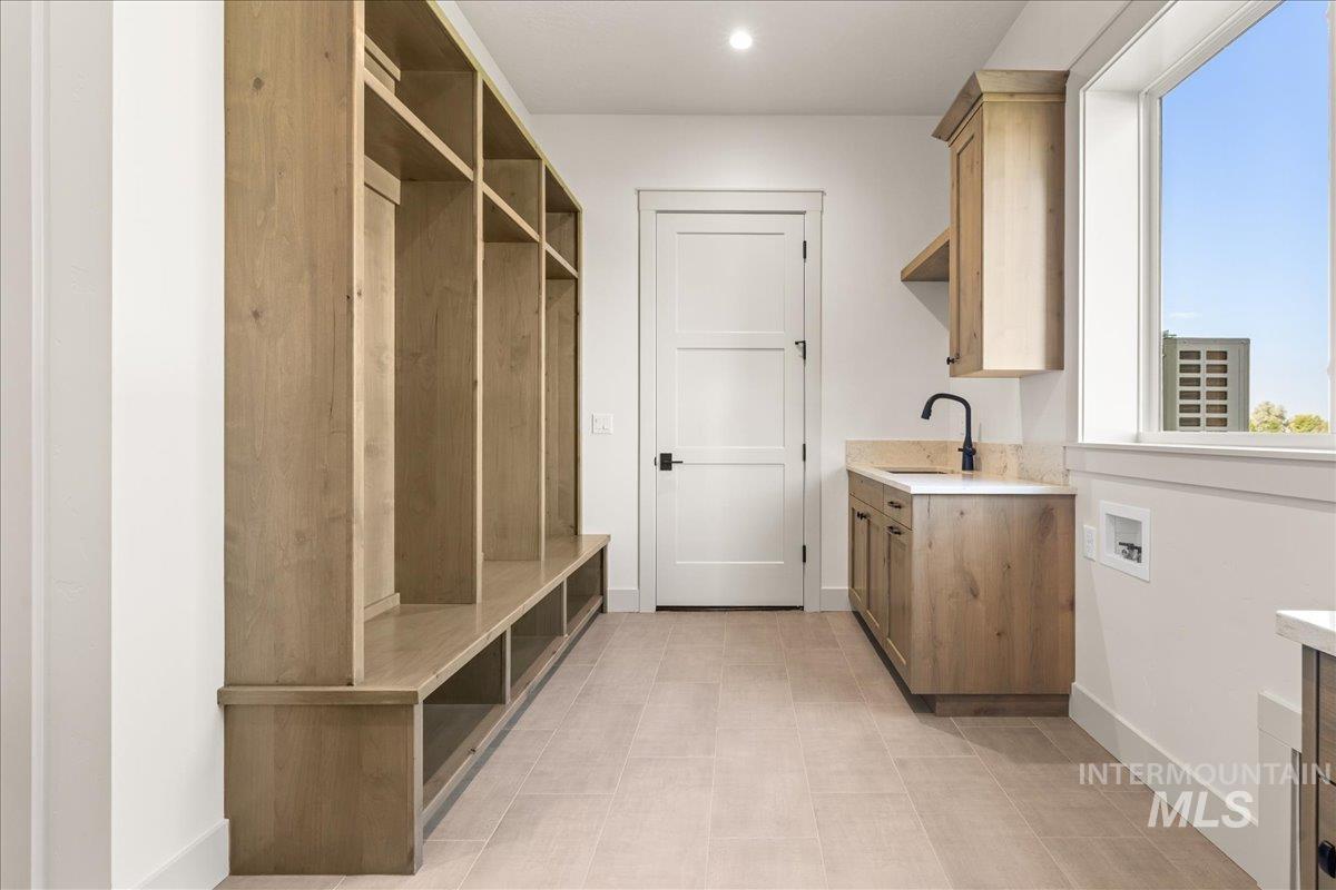 Mudroom with baseboards and a sink