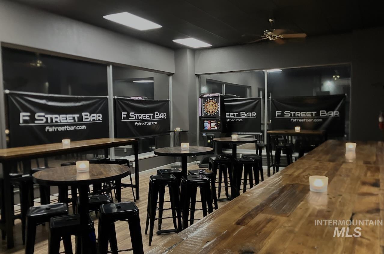Wine cellar with a ceiling fan and light wood-style flooring