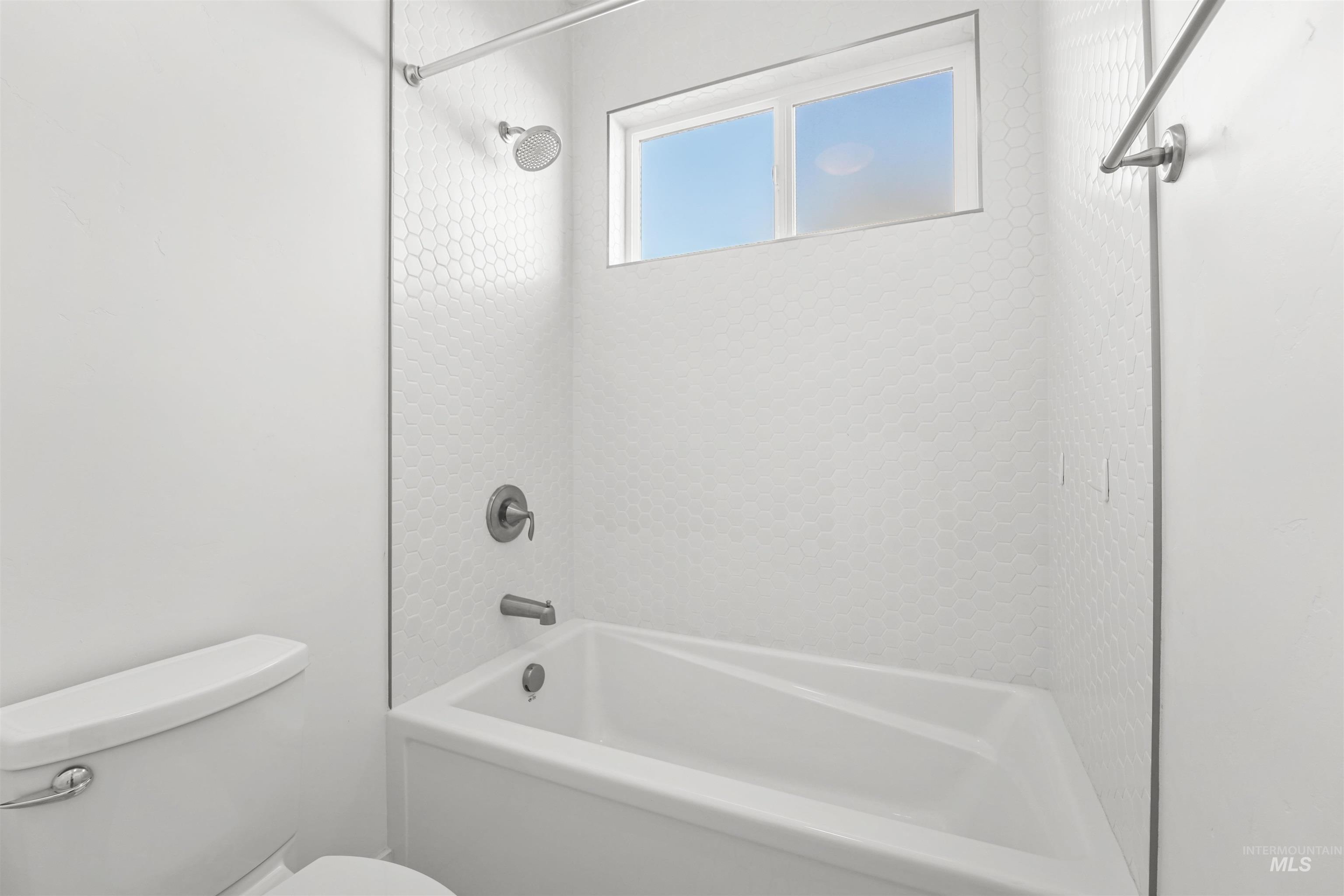 Full bathroom featuring toilet and shower / bath combination