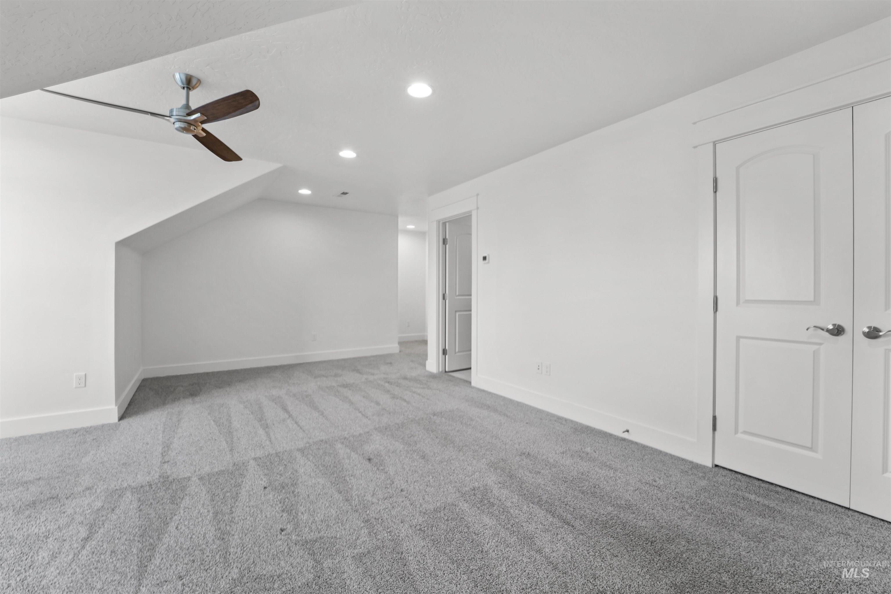 Bonus room featuring carpet floors, recessed lighting, and a ceiling fan