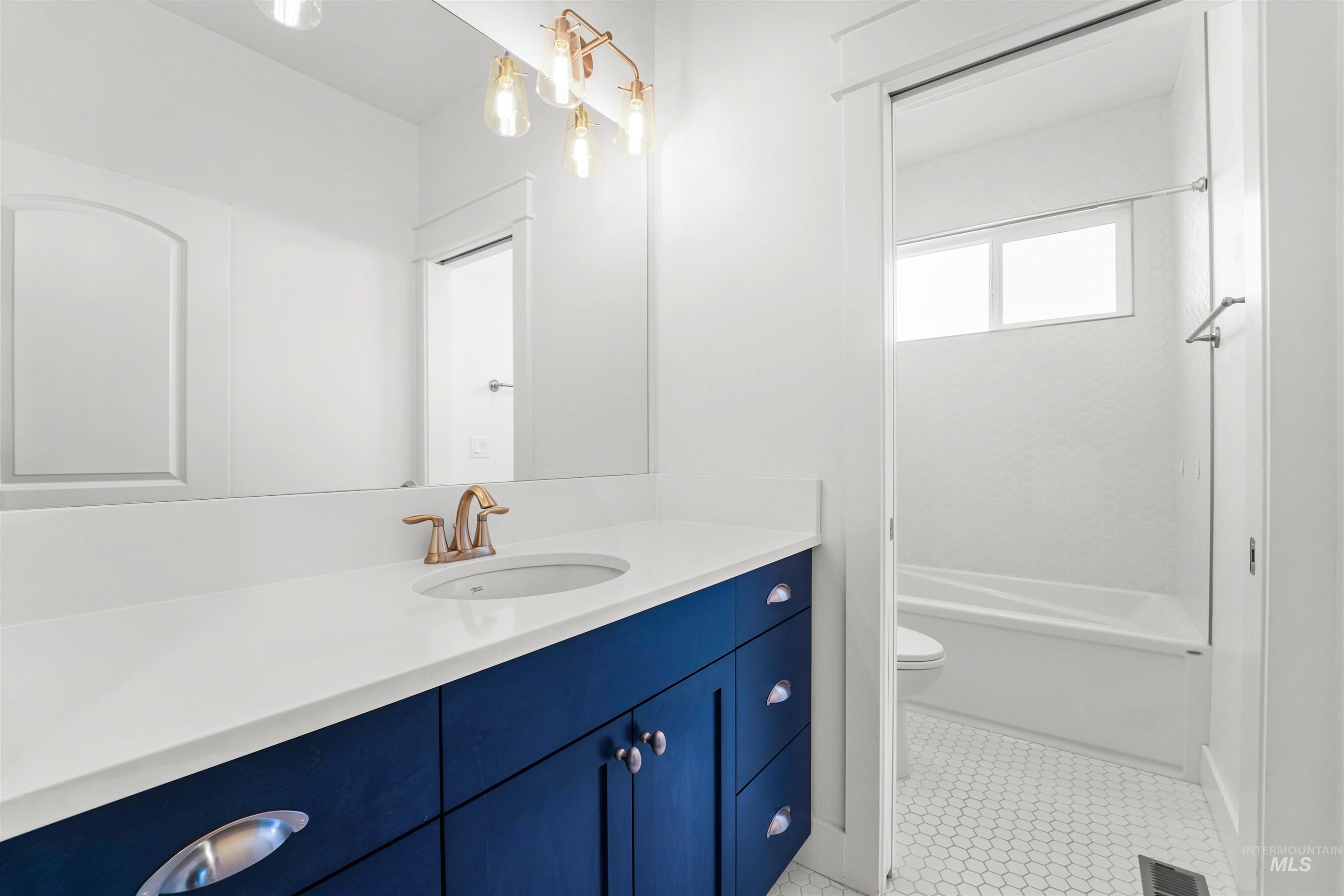 Full bath featuring vanity and shower / bath combination