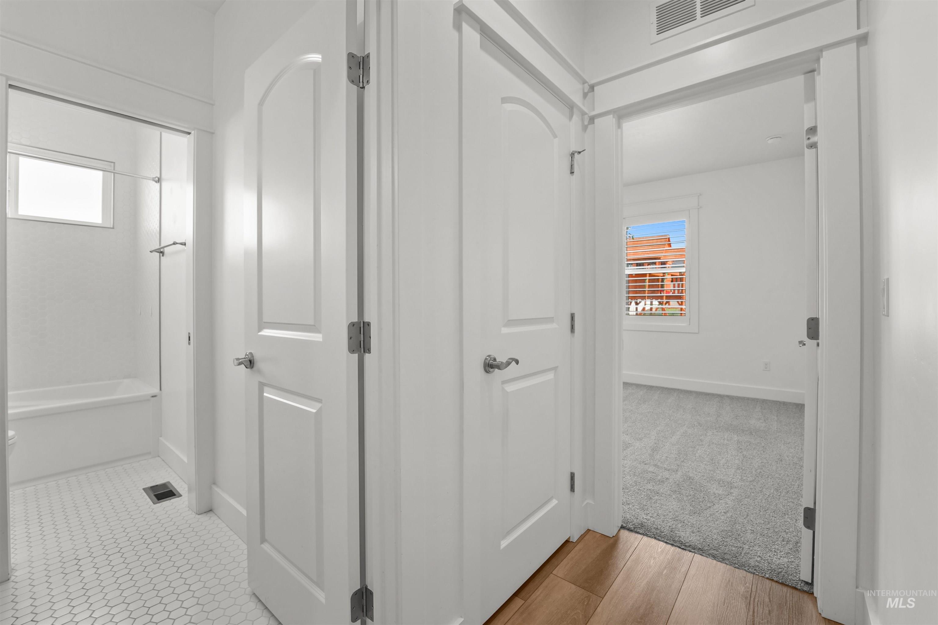 Corridor featuring baseboards and carpet floors