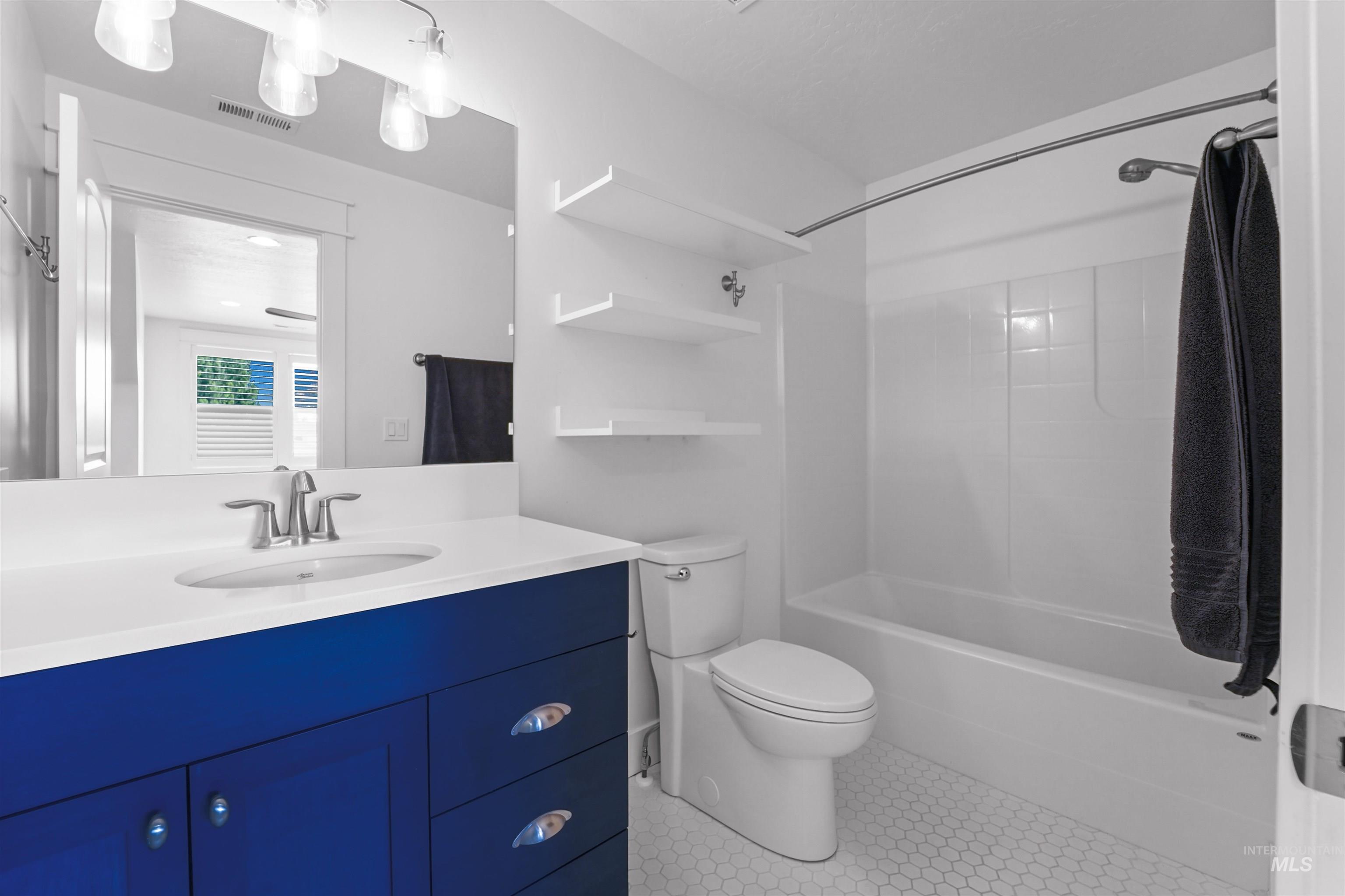 Full bathroom with vanity, bathing tub / shower combination, and tile patterned floors