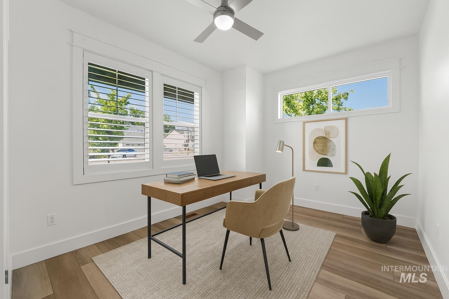 Office with a ceiling fan and wood finished floors
