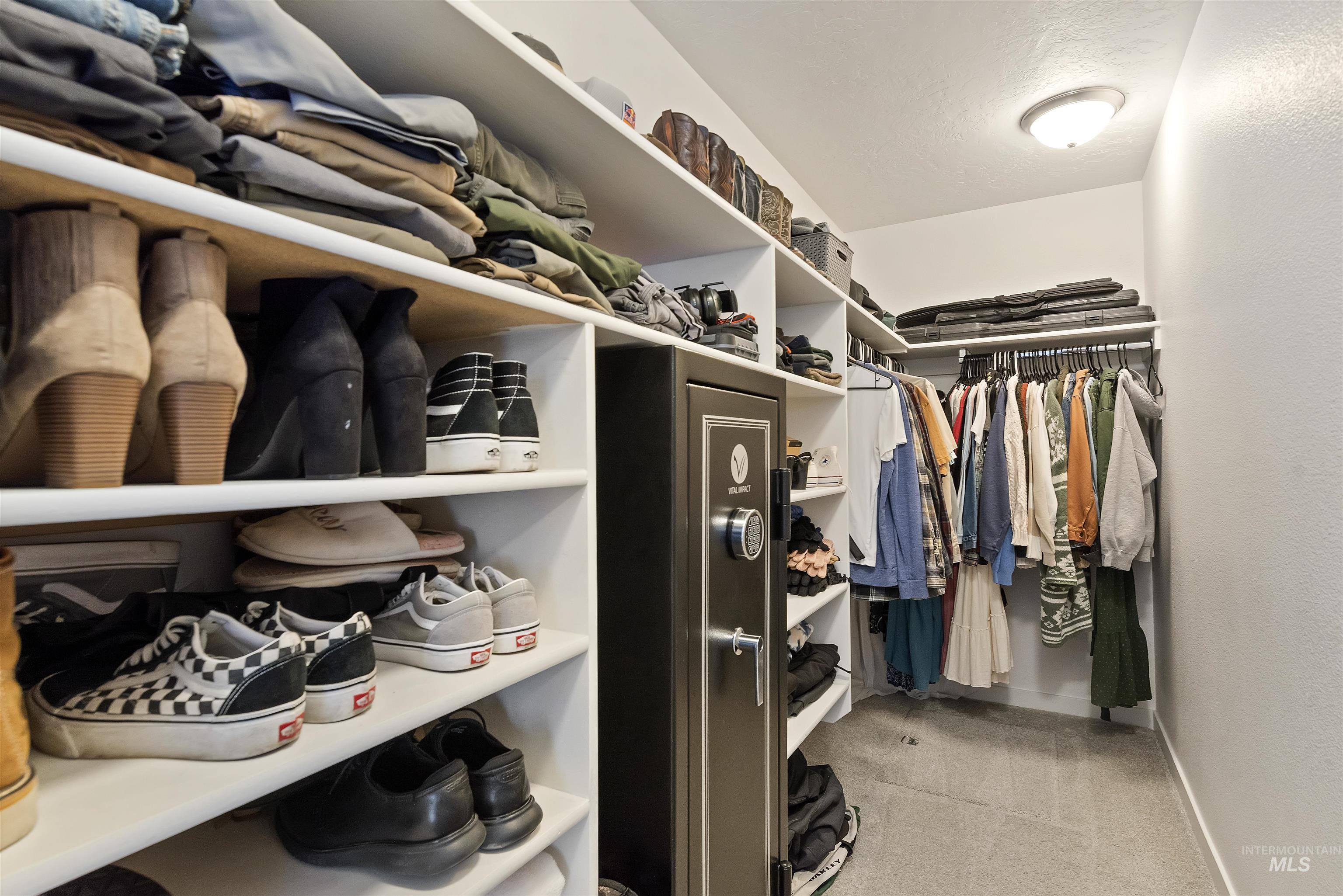 Walk in closet featuring light carpet